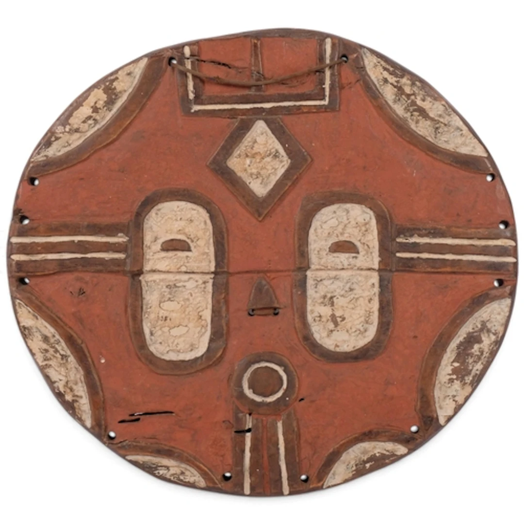 A Take Kidumu circular carved and painted wood face mask, Co...