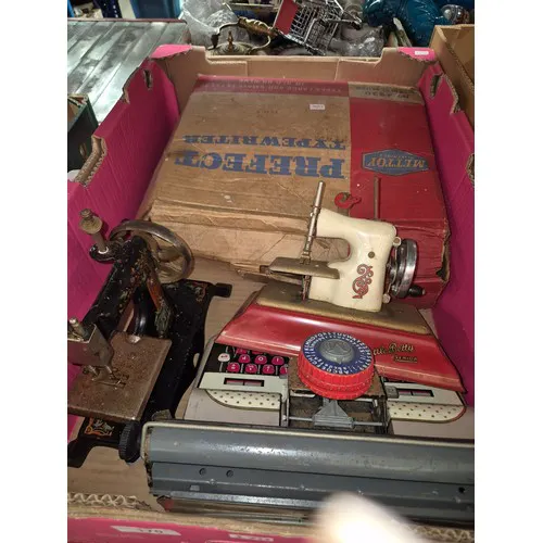 2 Mettoy typewriters and 2 child's sewing machines.