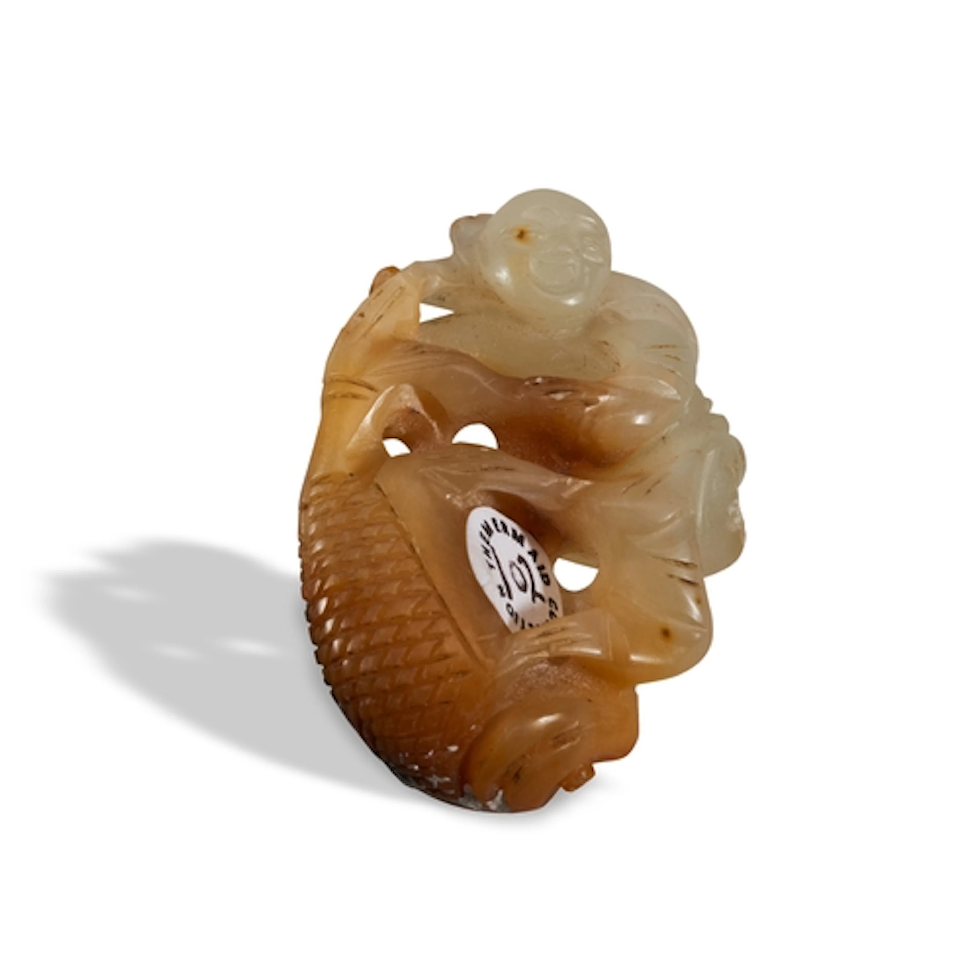 A CELADON AND RUSSET JADE 'BOY AND FISH' GROUP QING DYNASTY,...