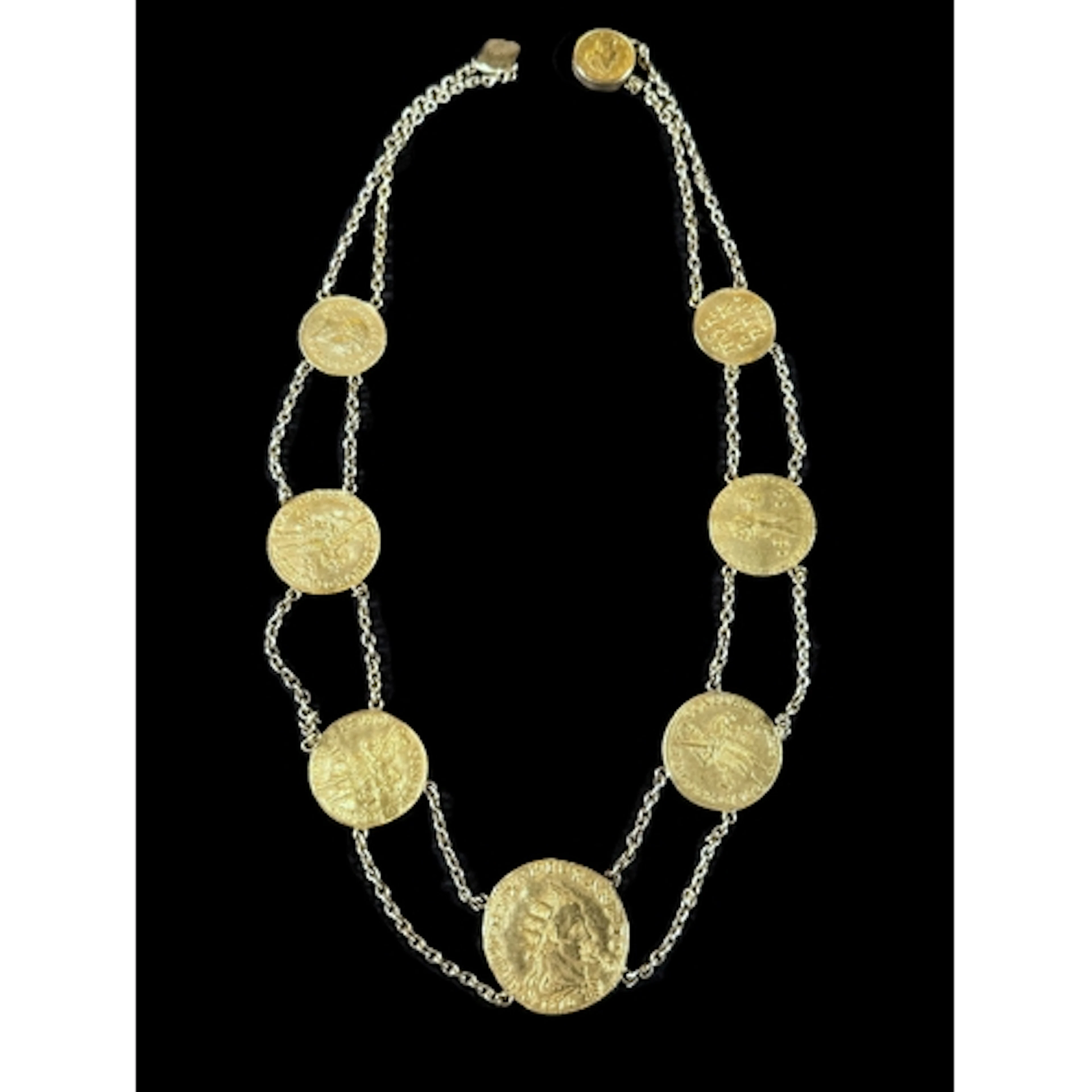 A yellow metal double stranded collar set with eight various...