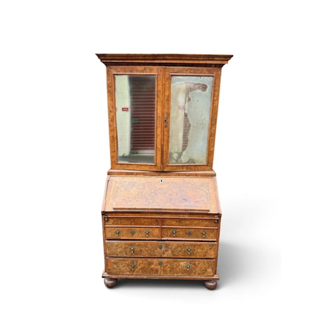 A WILLIAM AND MARY WALNUT AND FIGURED WALNUT BUREAU BOOKCASE...
