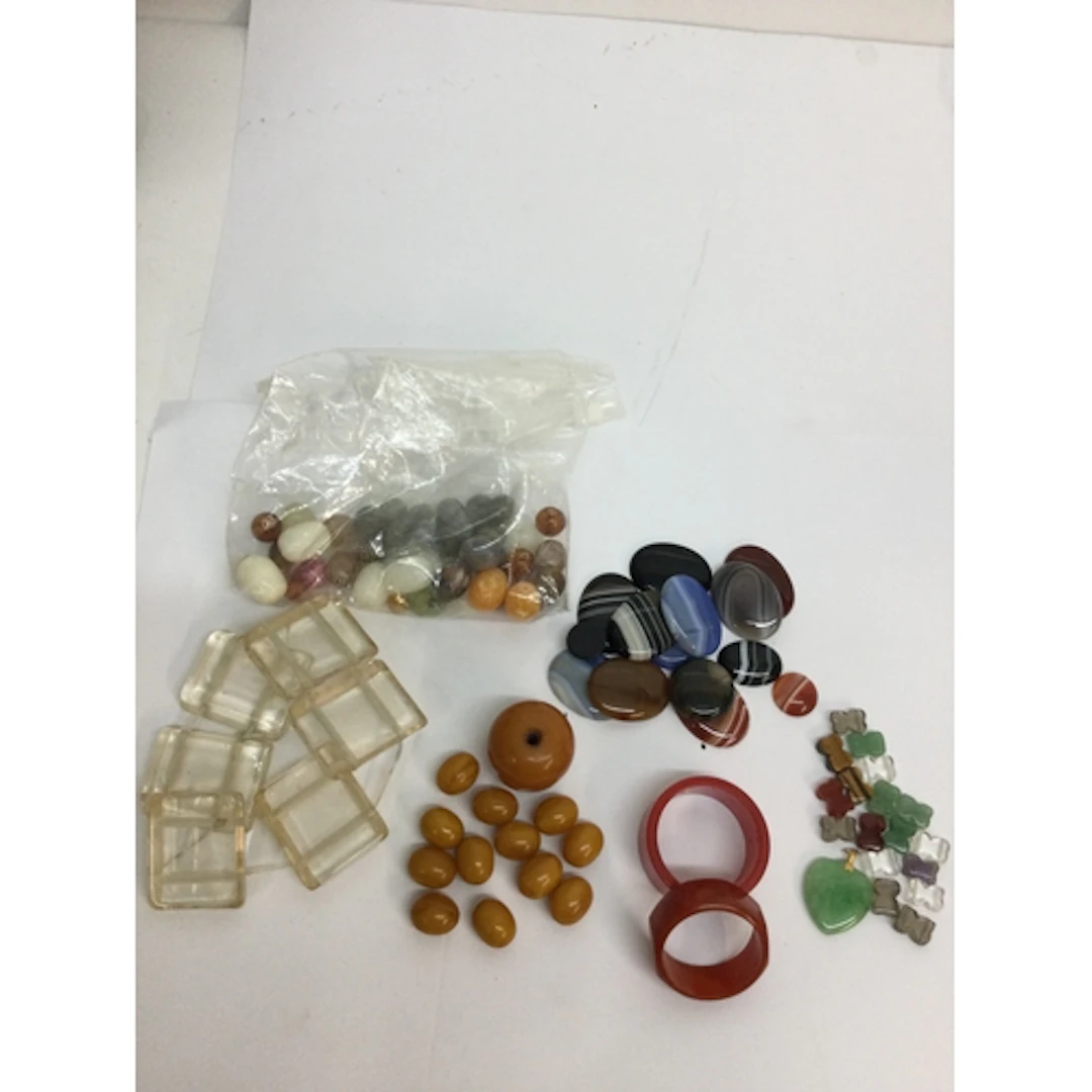 A small group of amber coloured early plastic beads, two Bak...