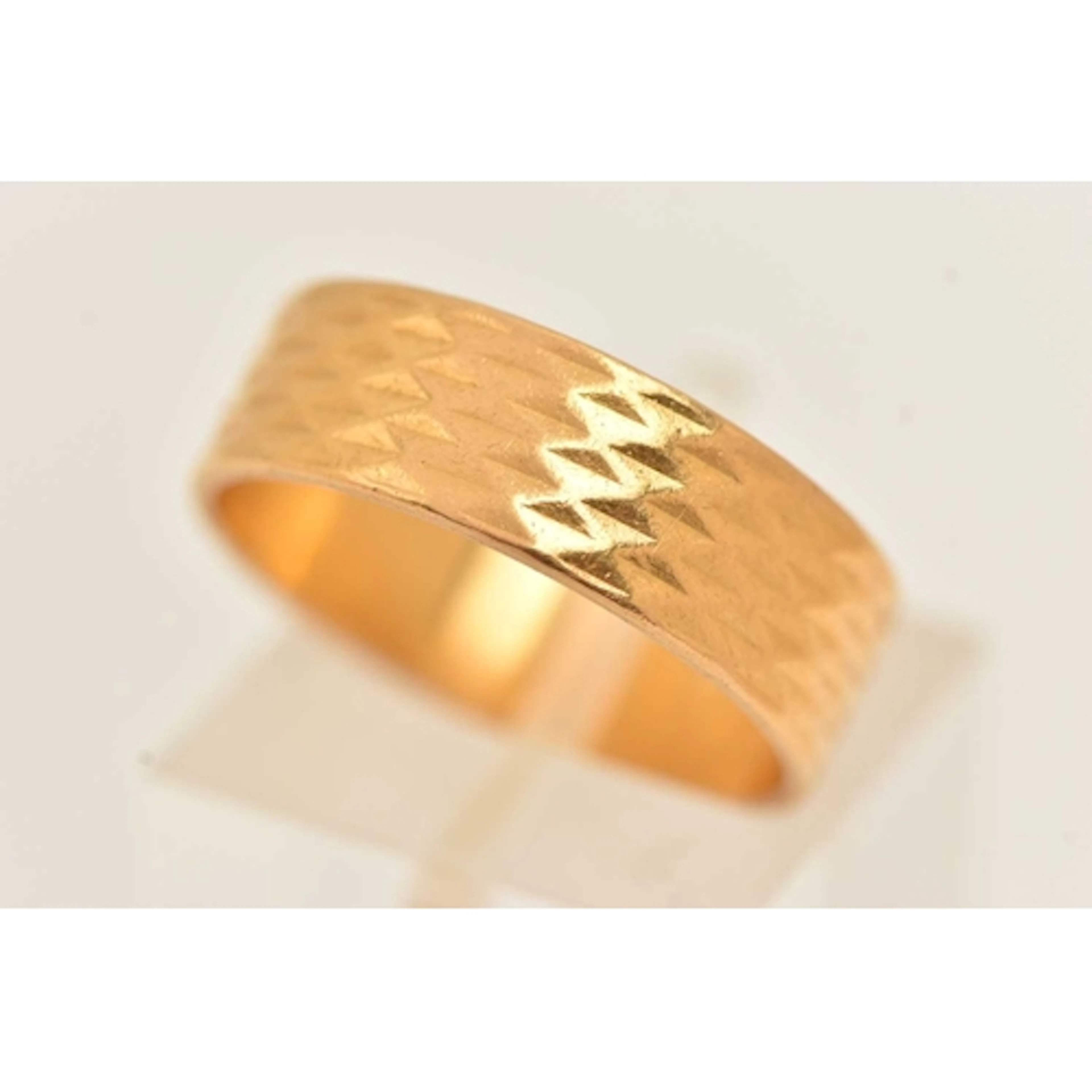 A 22CT GOLD TEXTURED WIDE BAND RING, approximate band width ...