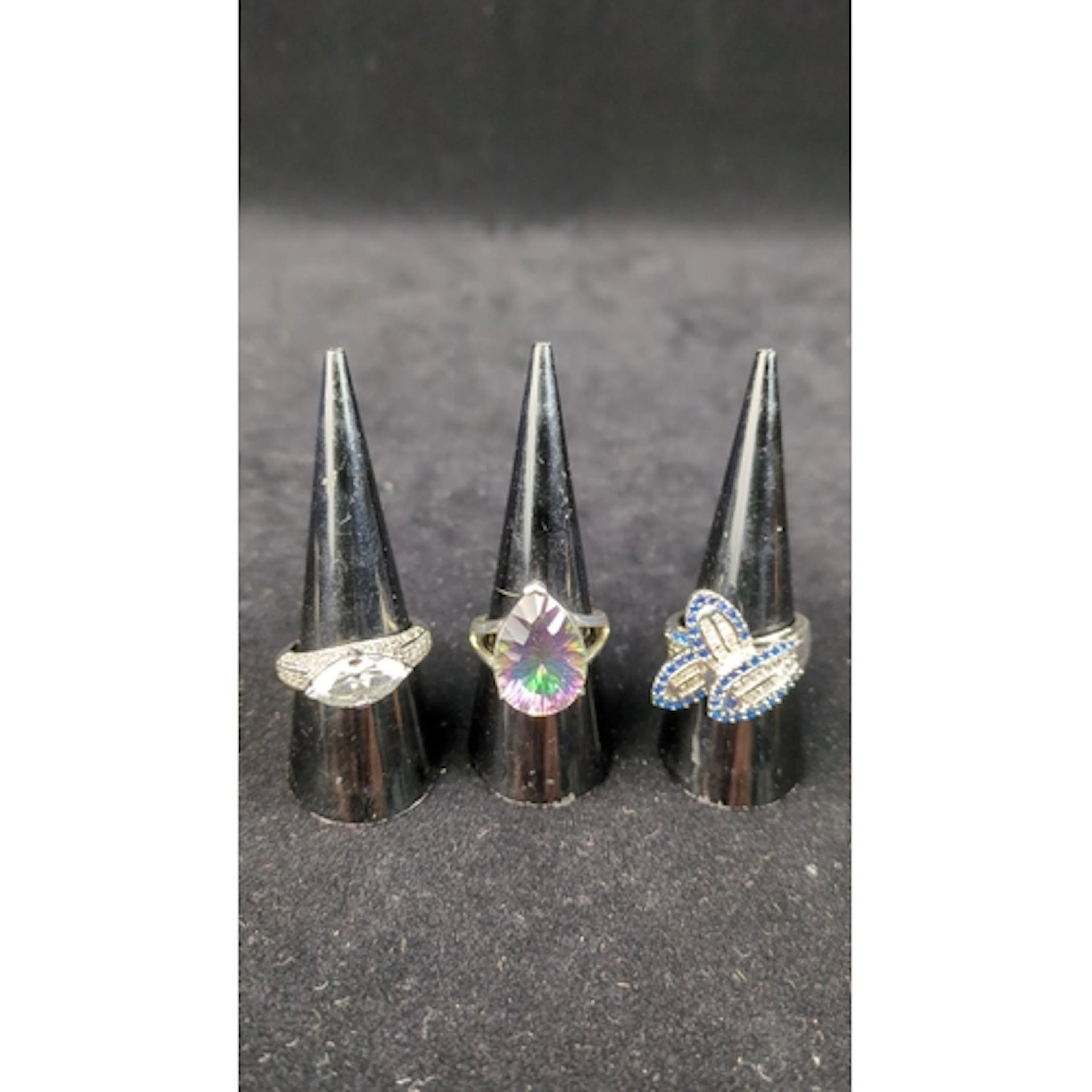 Three sterling silver rings, each stamped 925: one with a ma...