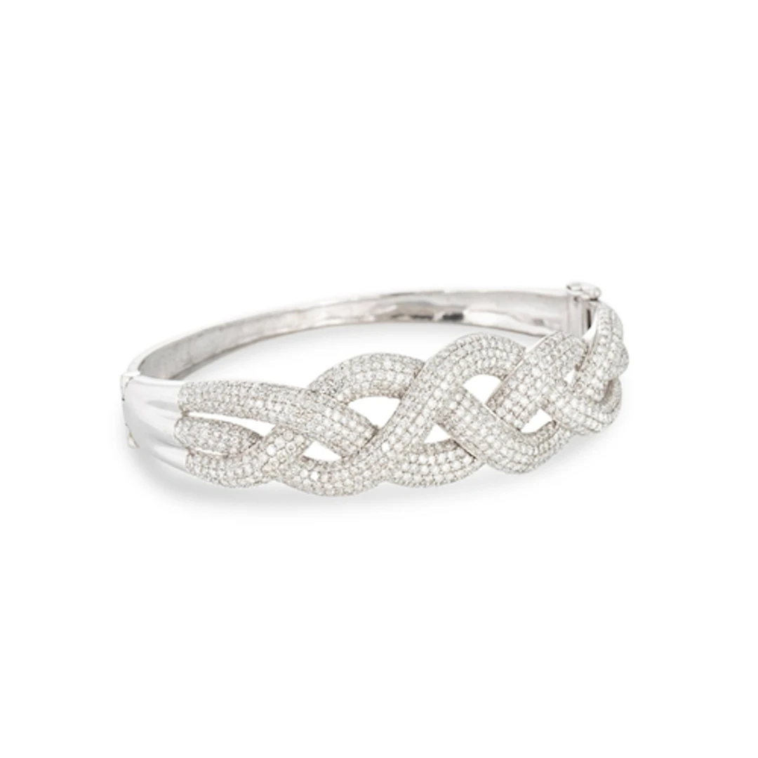 A DIAMOND BANGLE, mounted in white gold stamped 9 ct, of wov...