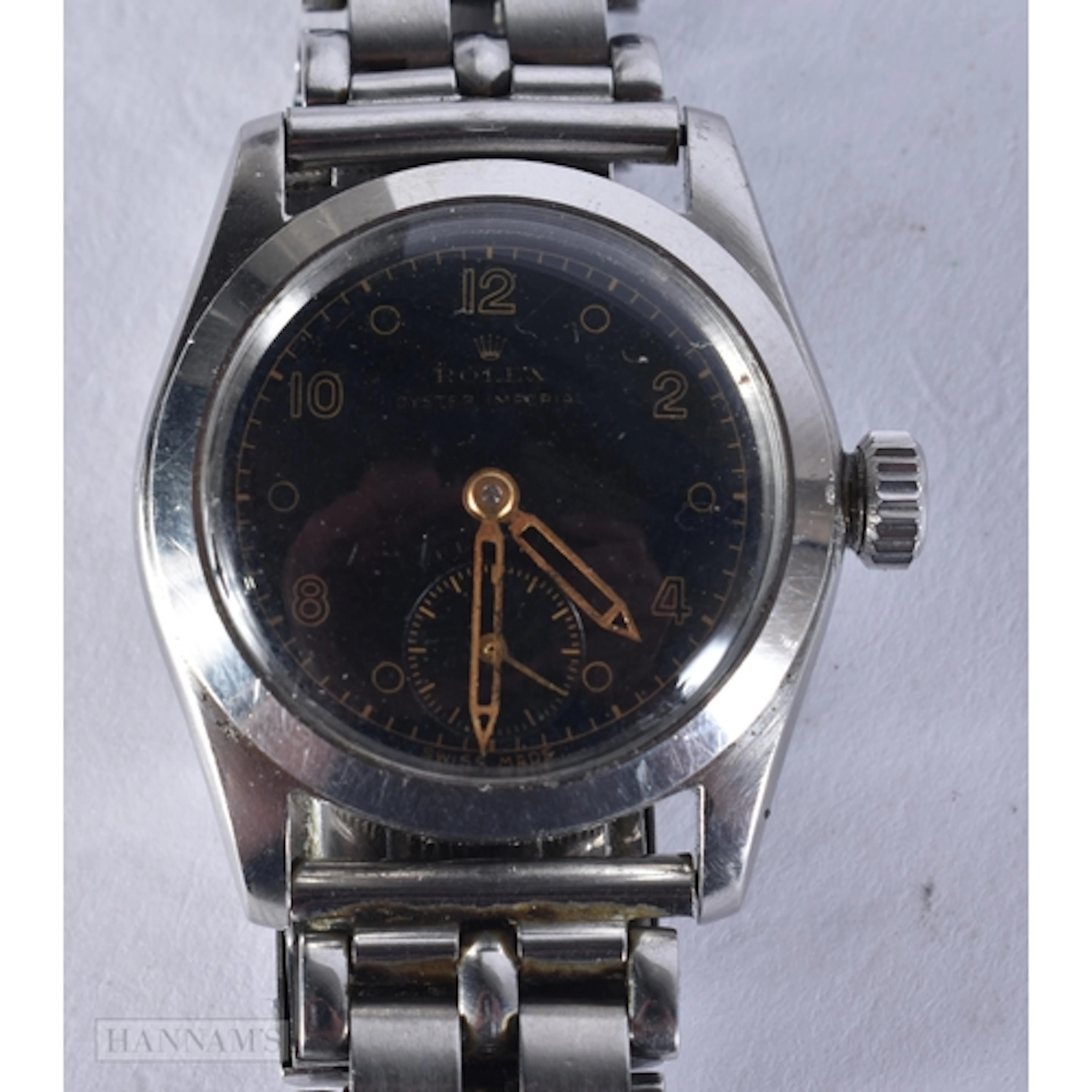 A BLACK DIAL ROLEX. 3.3 cm including crown. running