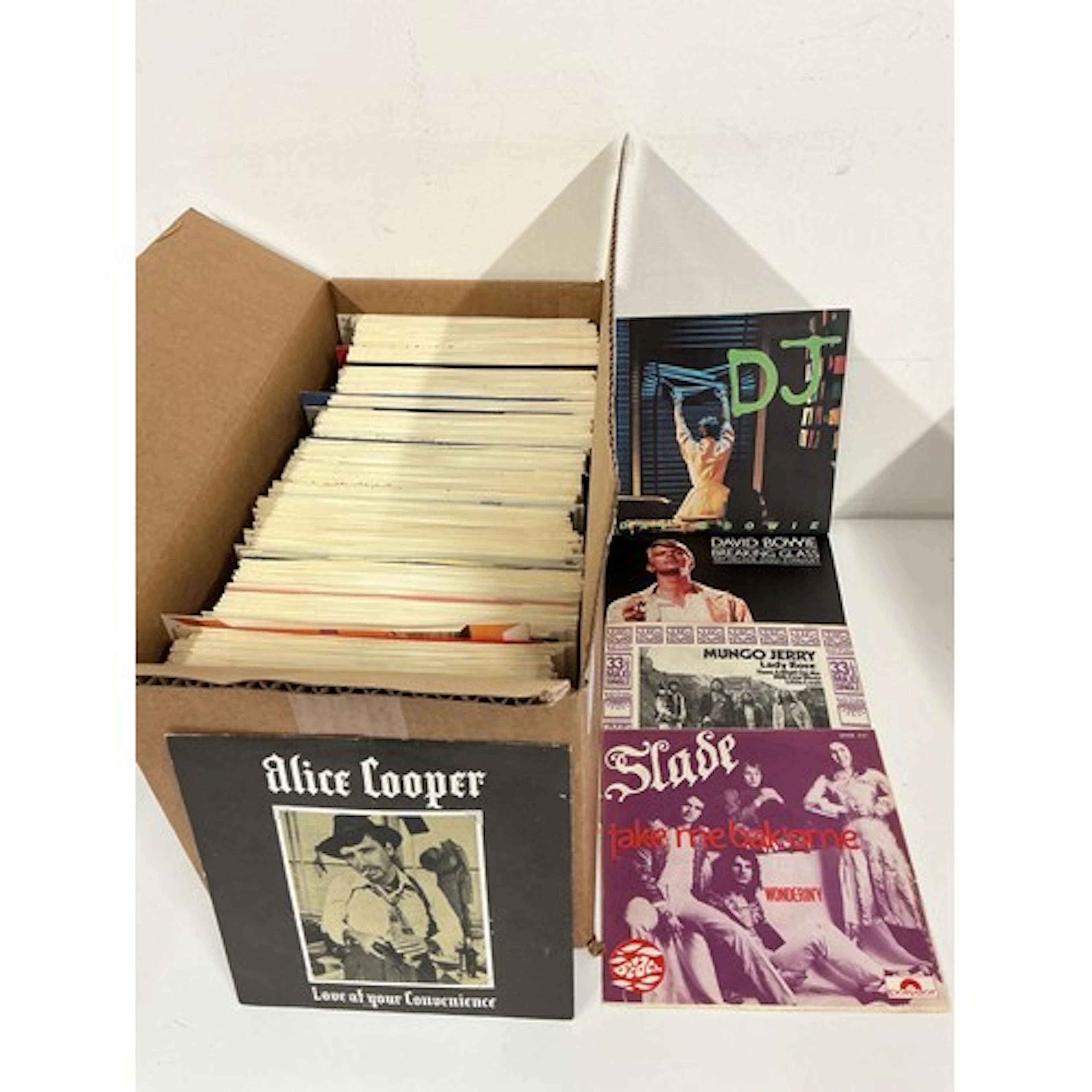 A collection of 7” singles by various artists including Alic...