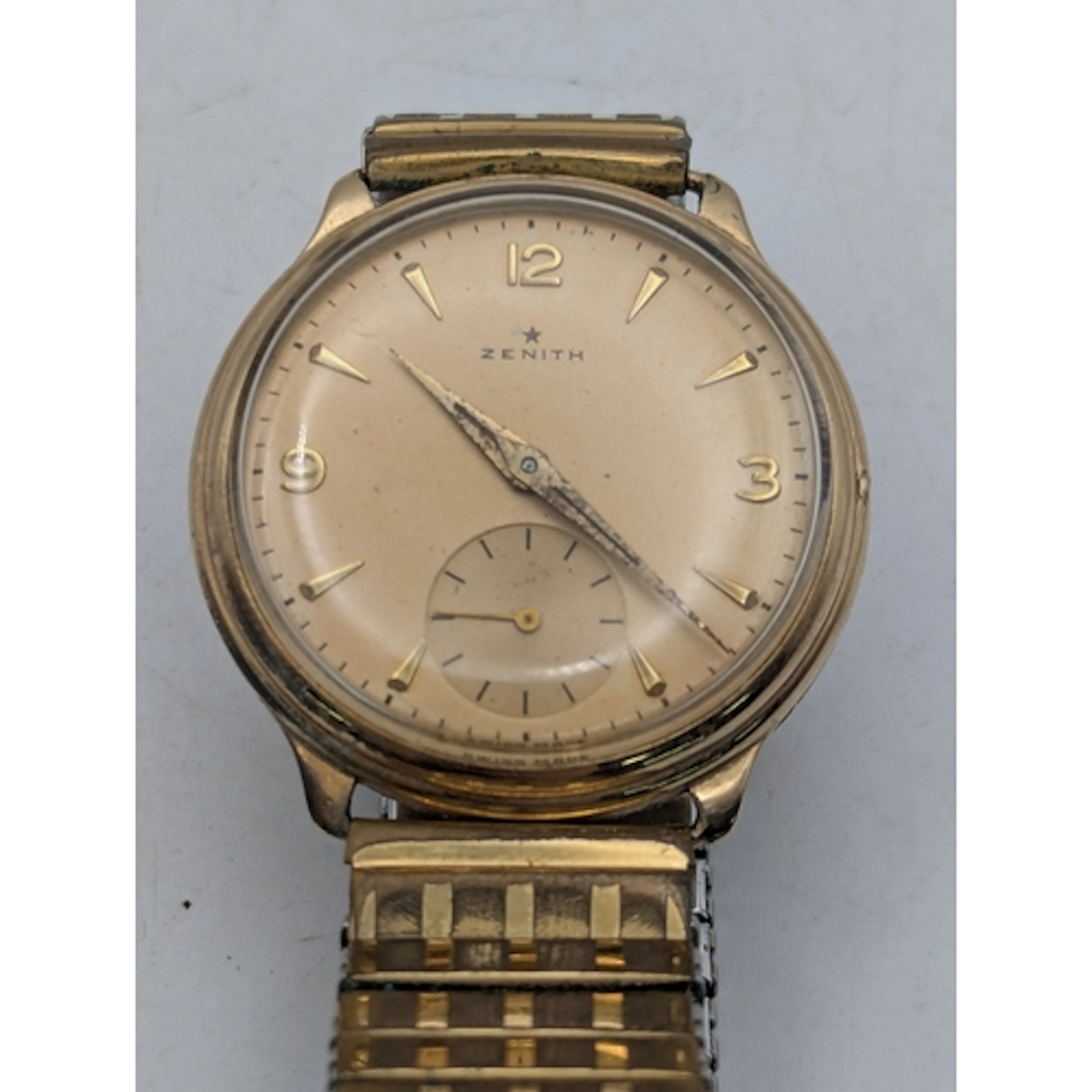 A 9ct yellow gold cased Zenith gents wrist watch A/F, on a g...