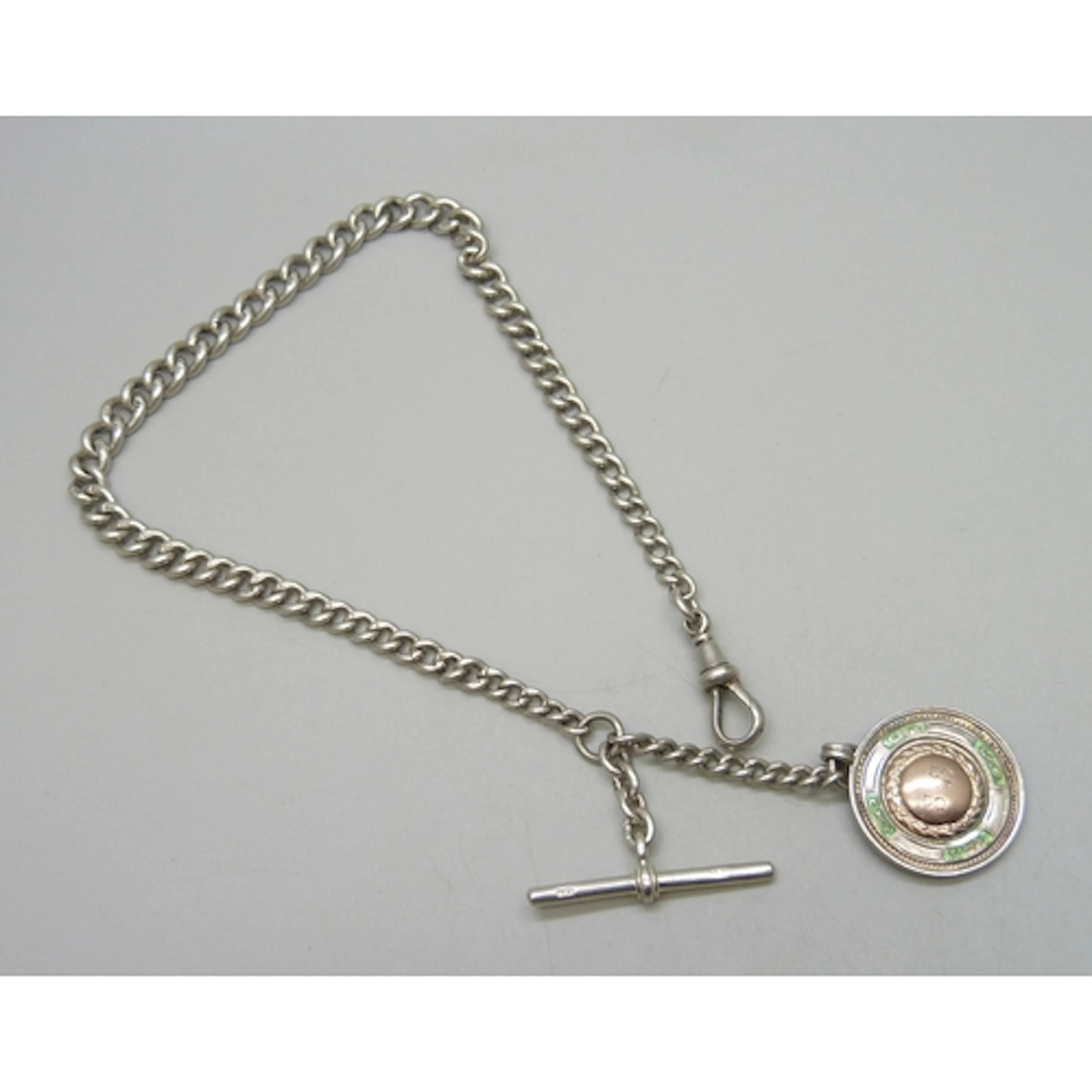 A silver Albert chain with a silver, enamel and applied yell...