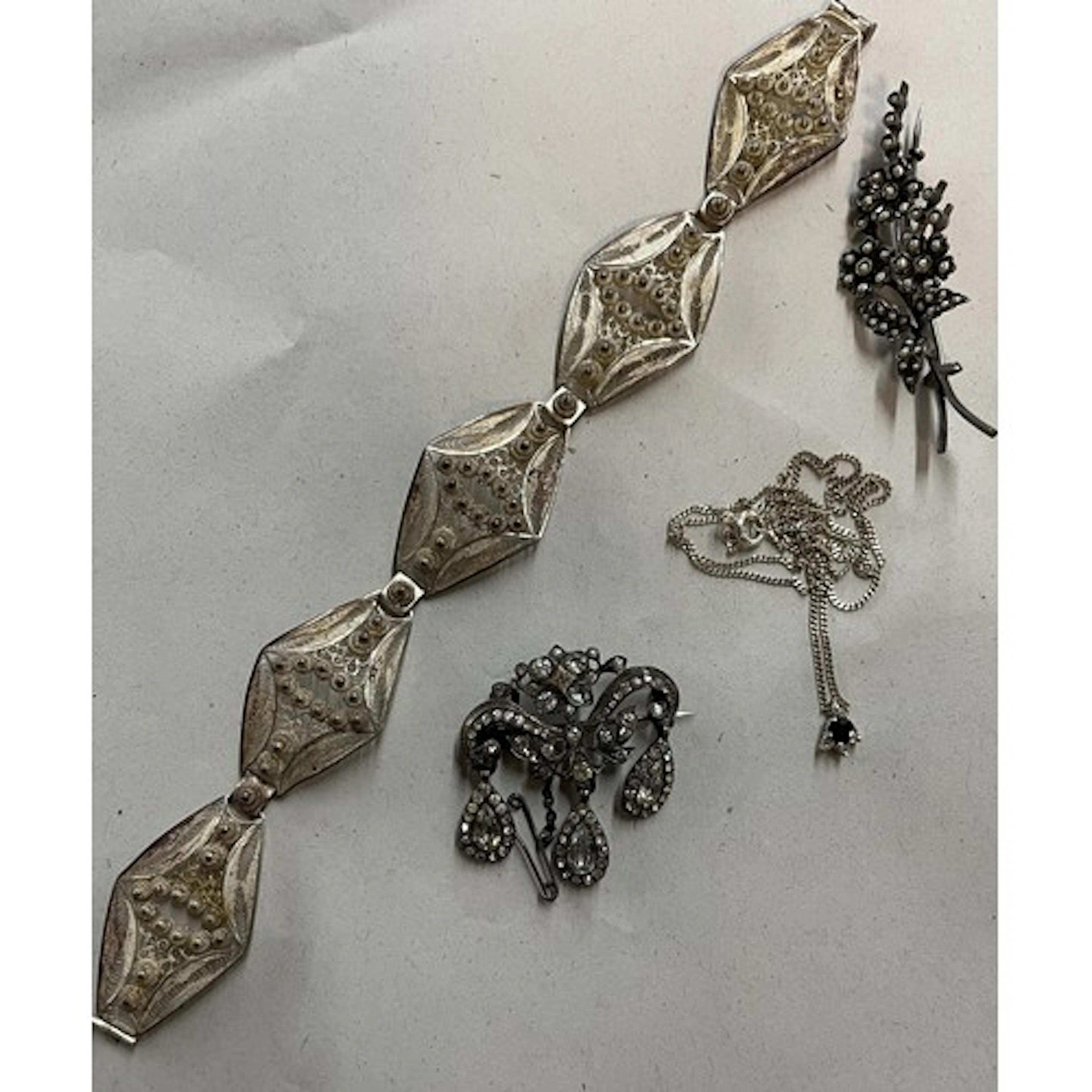 Four pieces of jewellery, including a 19th style paste set b...