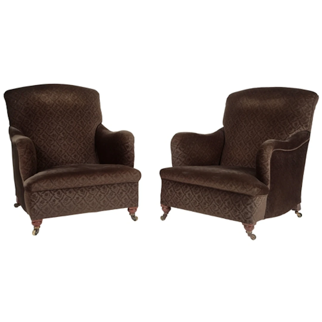 A pair of Victorian Howard & Sons Bridgewater type armchairs...