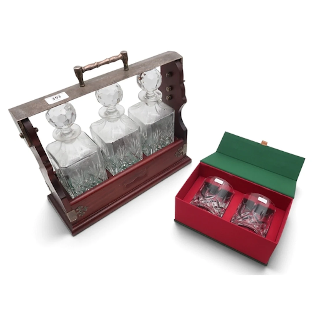 A three decanter tantalus, together with a pair of Royal Dou...