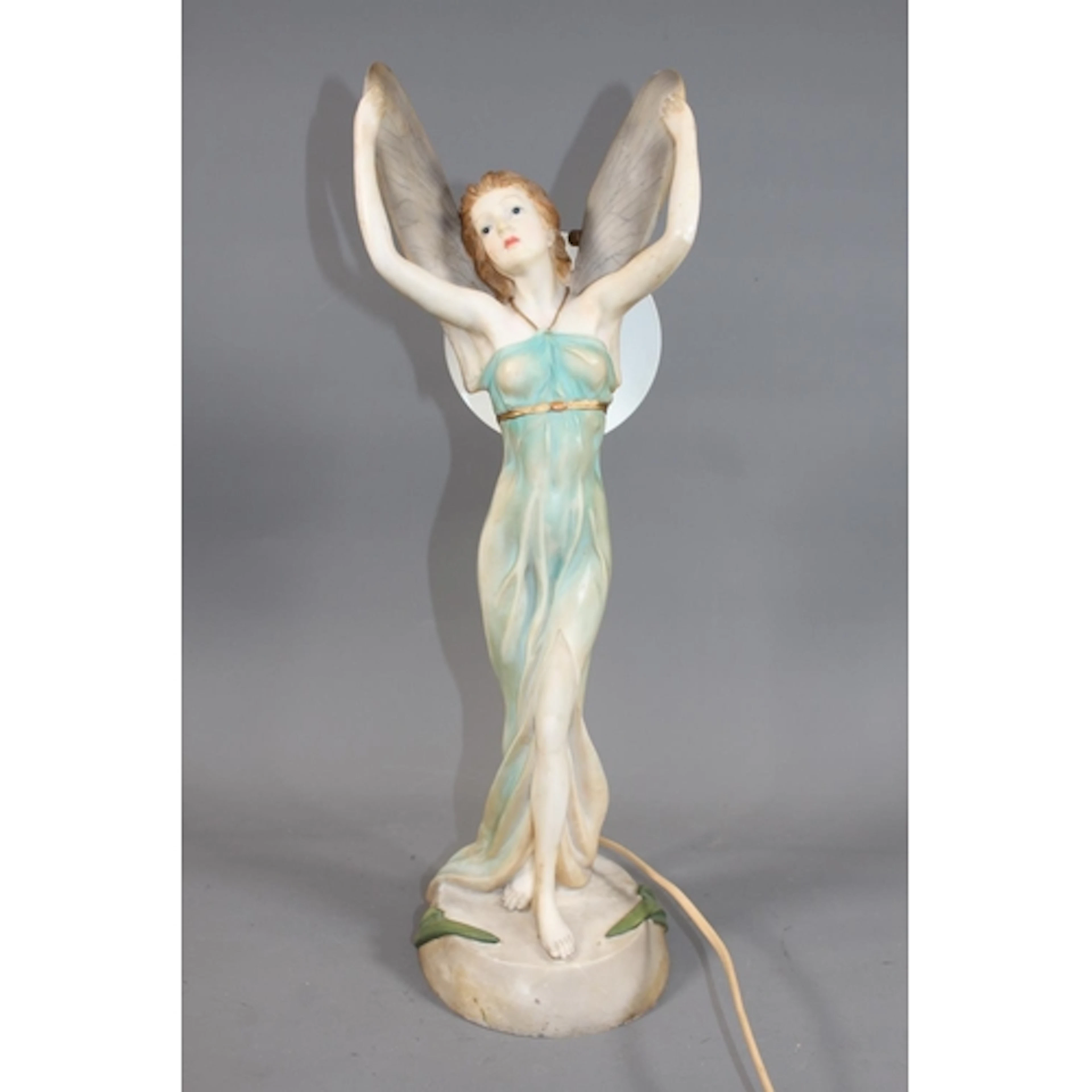 Resin figure of a fairy standing with arms aloft table lamp,...