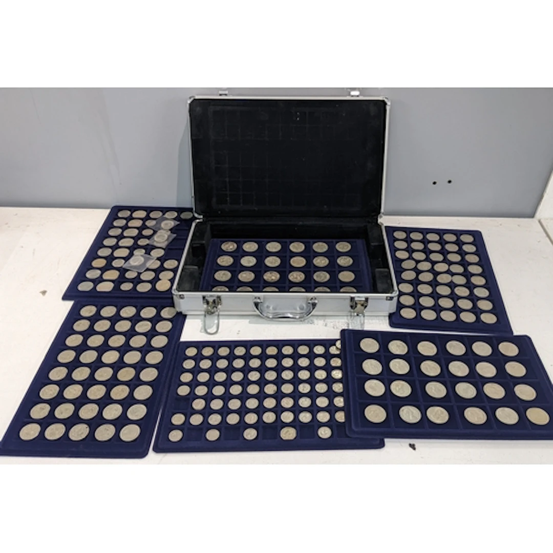 An aluminium case containing a collection of British coins t...