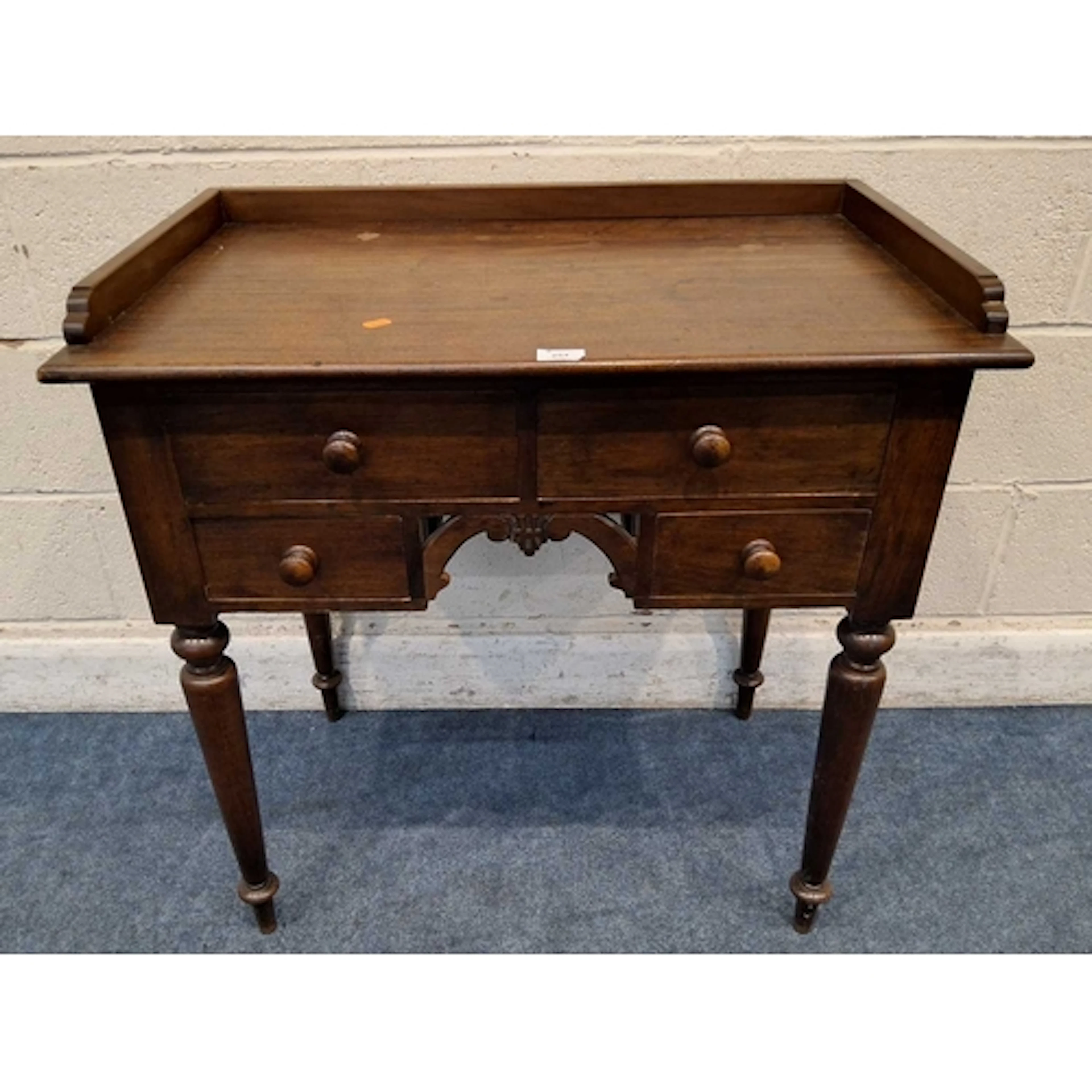 A GEORGIAN AND LATER MAHOGANY LOWBOY, with a raised gallery,...
