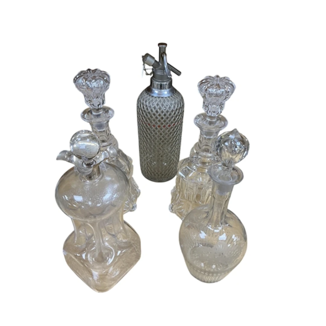 An early 20th century silver mounted decanter, three others ...