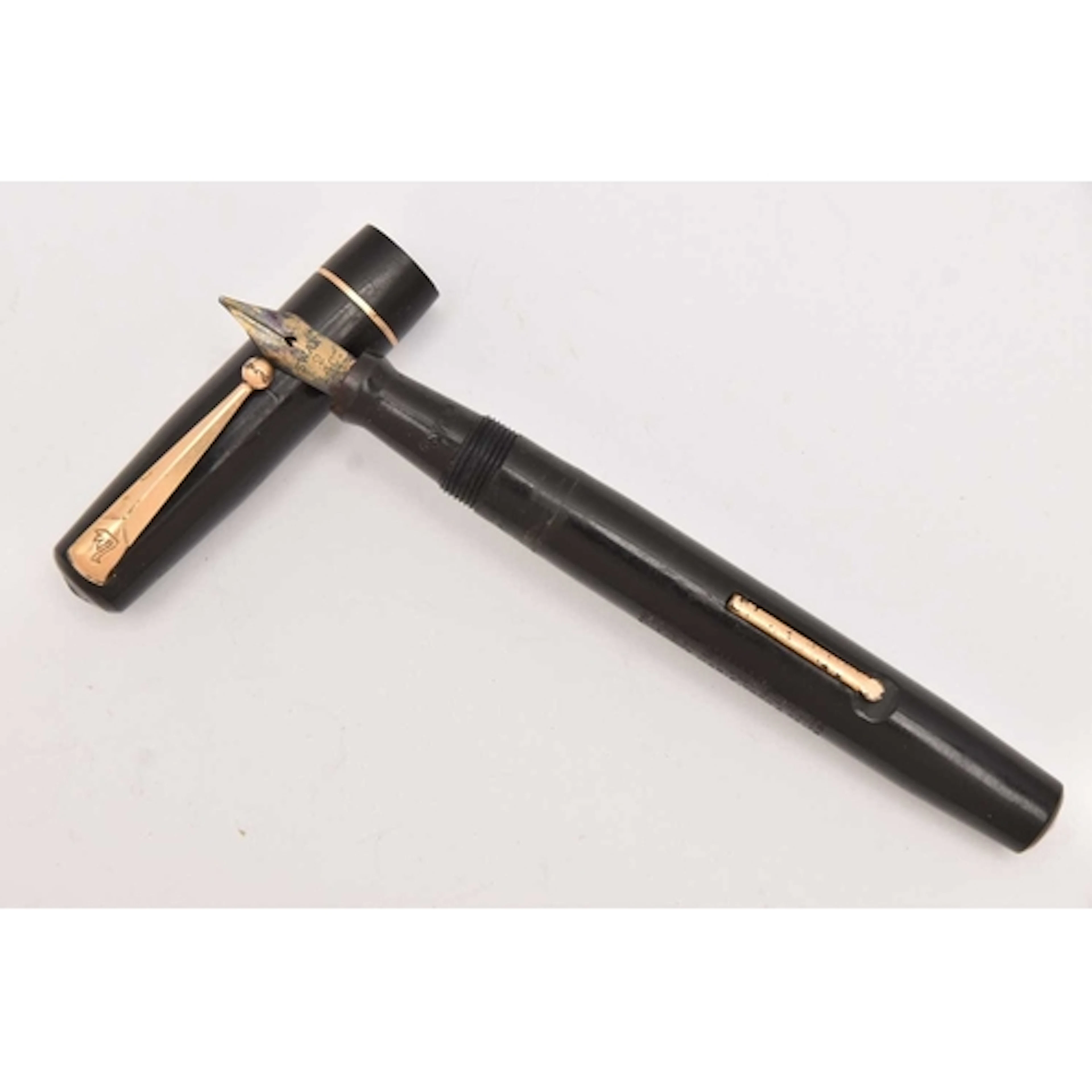 A 'SWAN' FOUNTAIN PEN, black a yellow metal pen signed 'Swan...