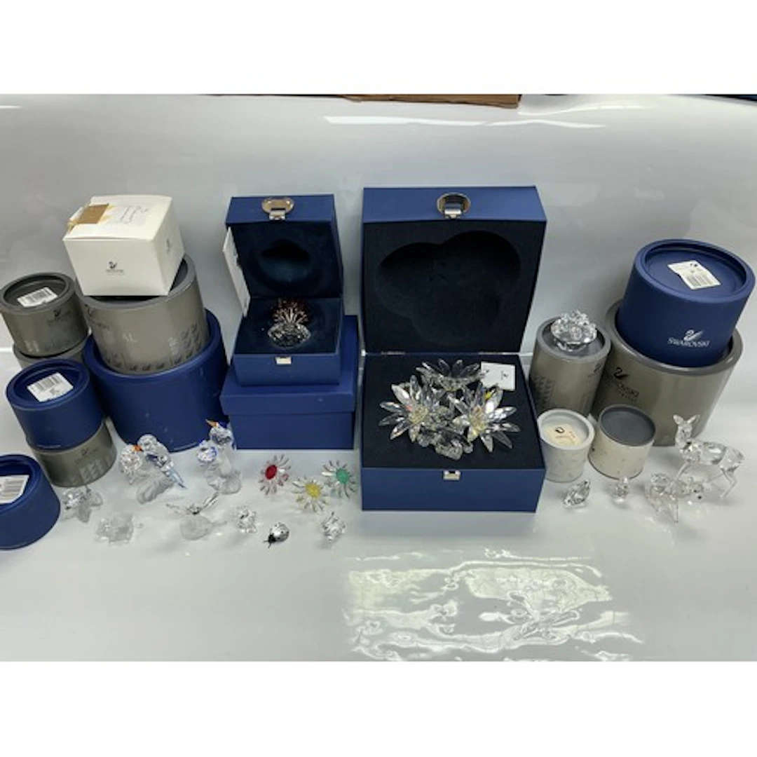A collection of boxed Swarovski items comprising animals and...