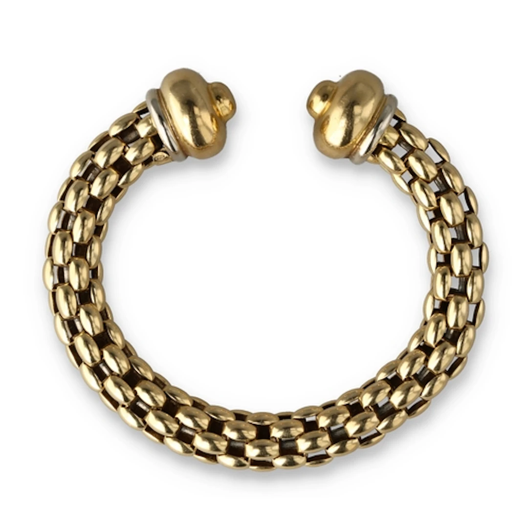 AN 18CT GOLD CUFF BANGLE Signed. With metal core. Gross weig...