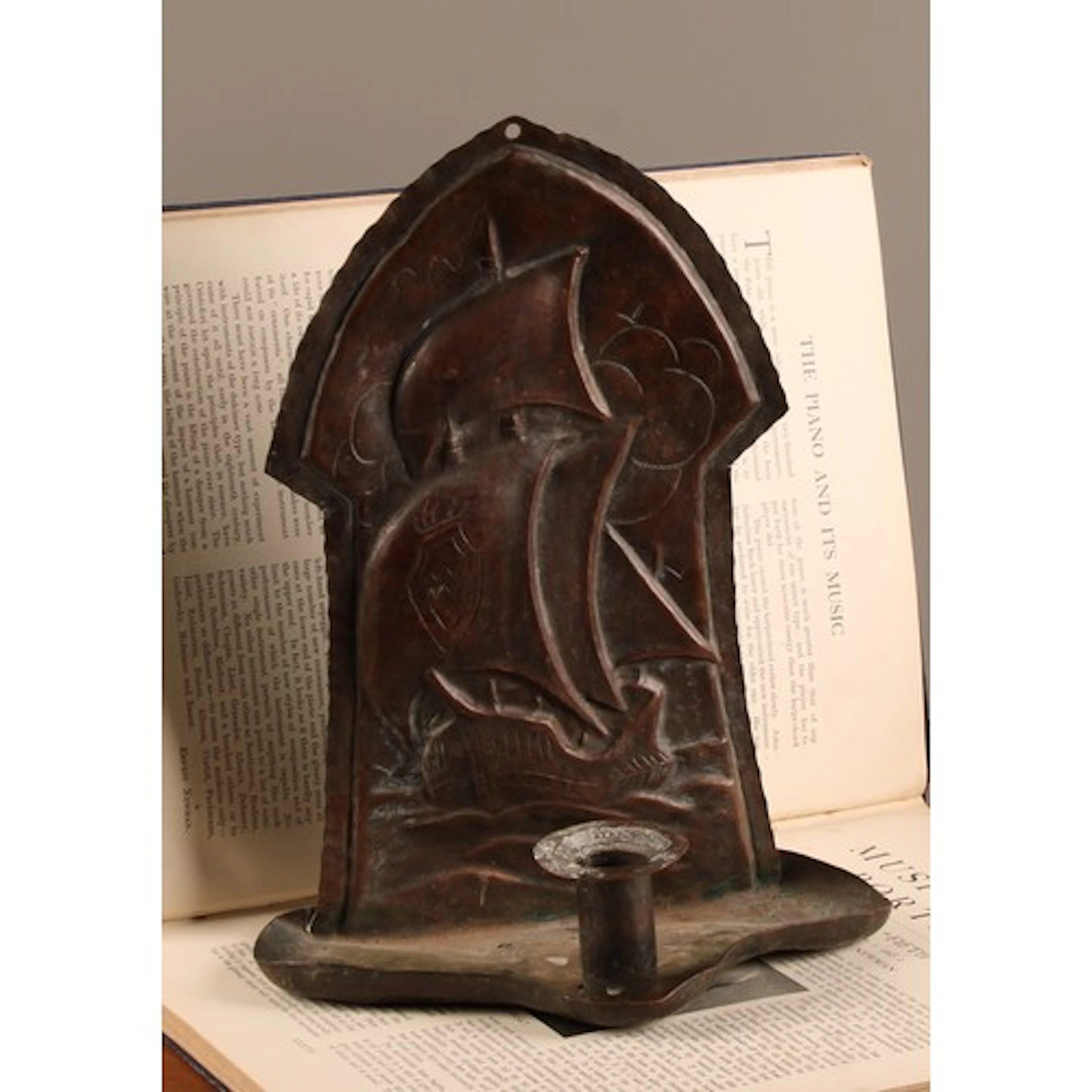 A late 19th century Arts and Crafts copper candle wall sconc...