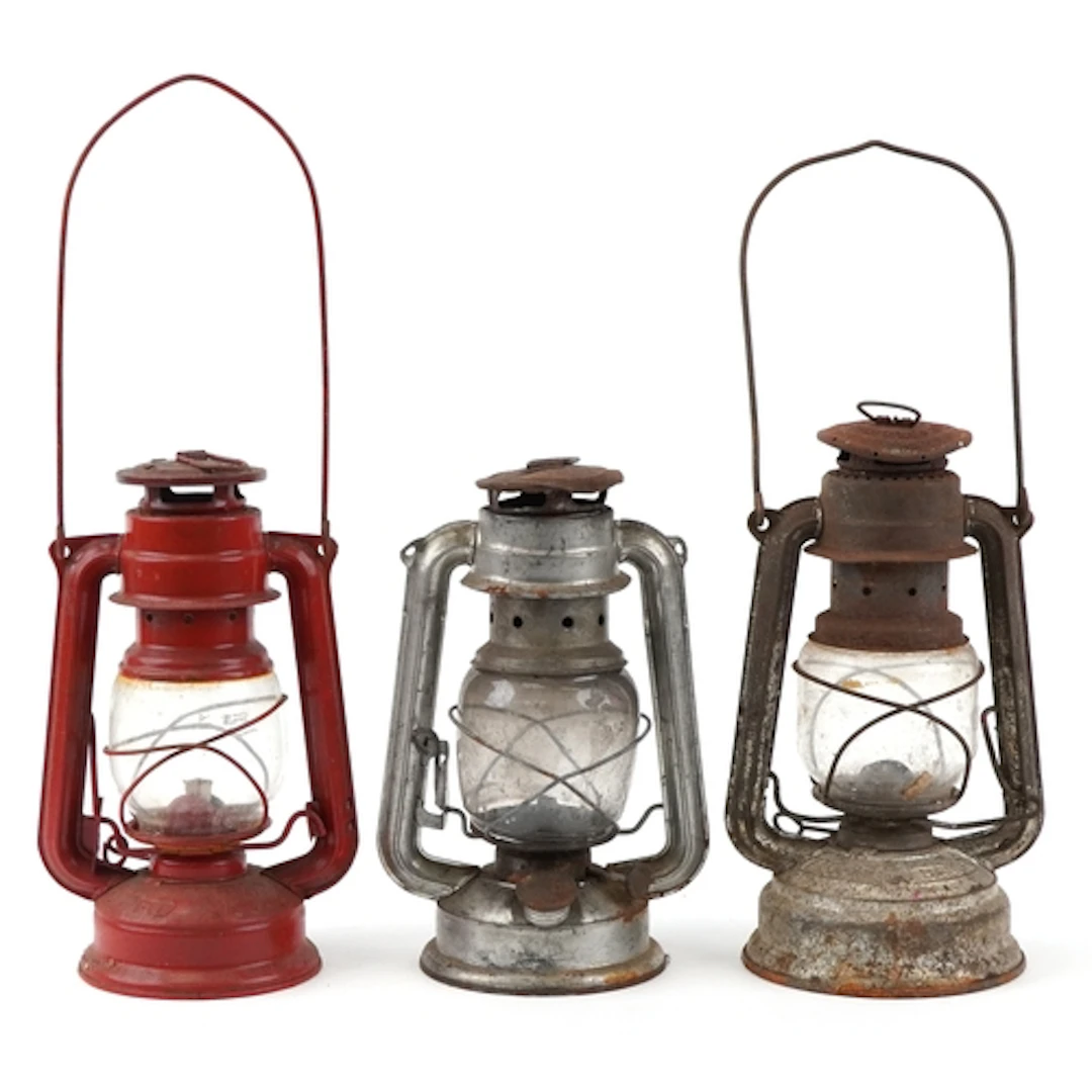 Three vintage tin oil lamps, the largest 23cm high