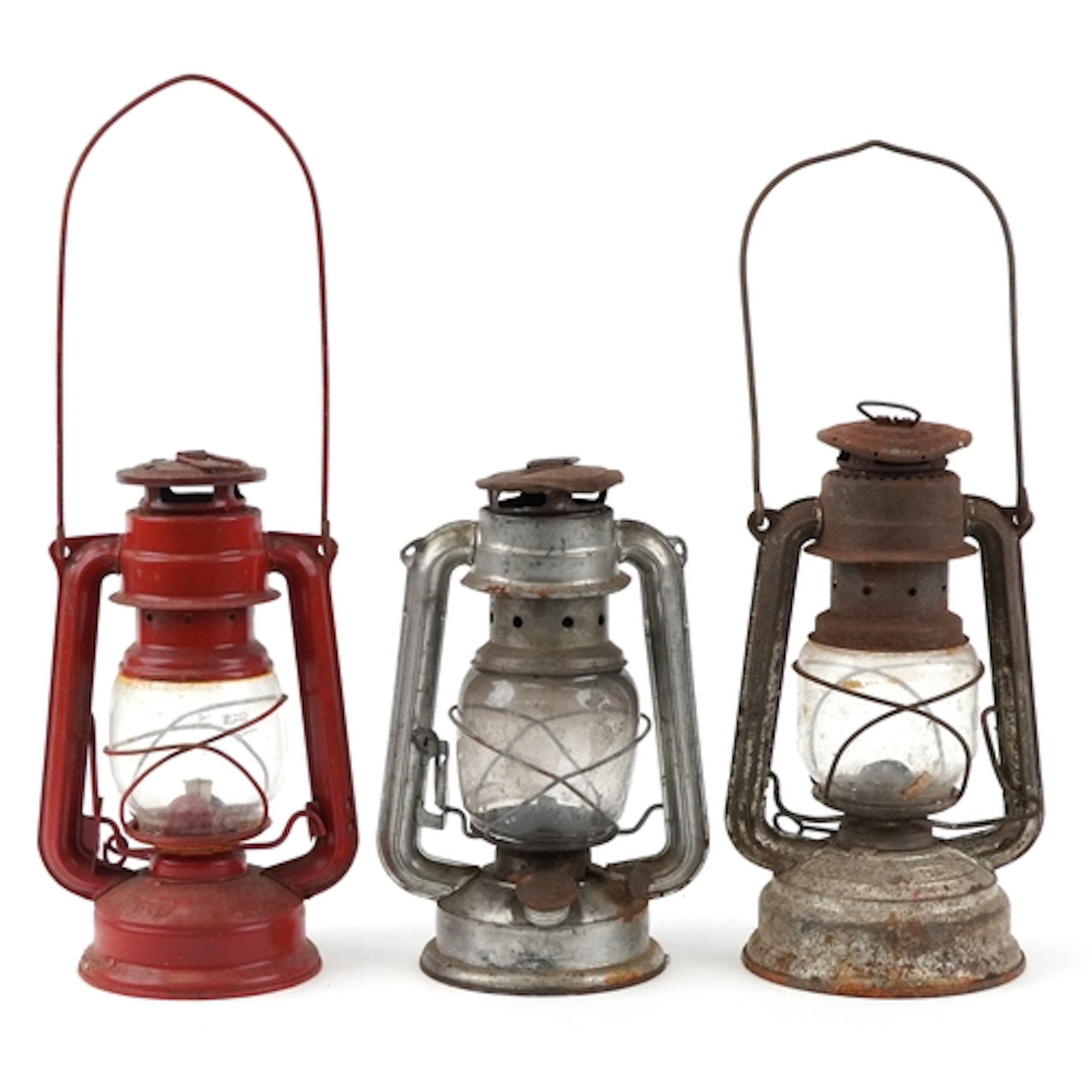 Three vintage tin oil lamps, the largest 23cm high