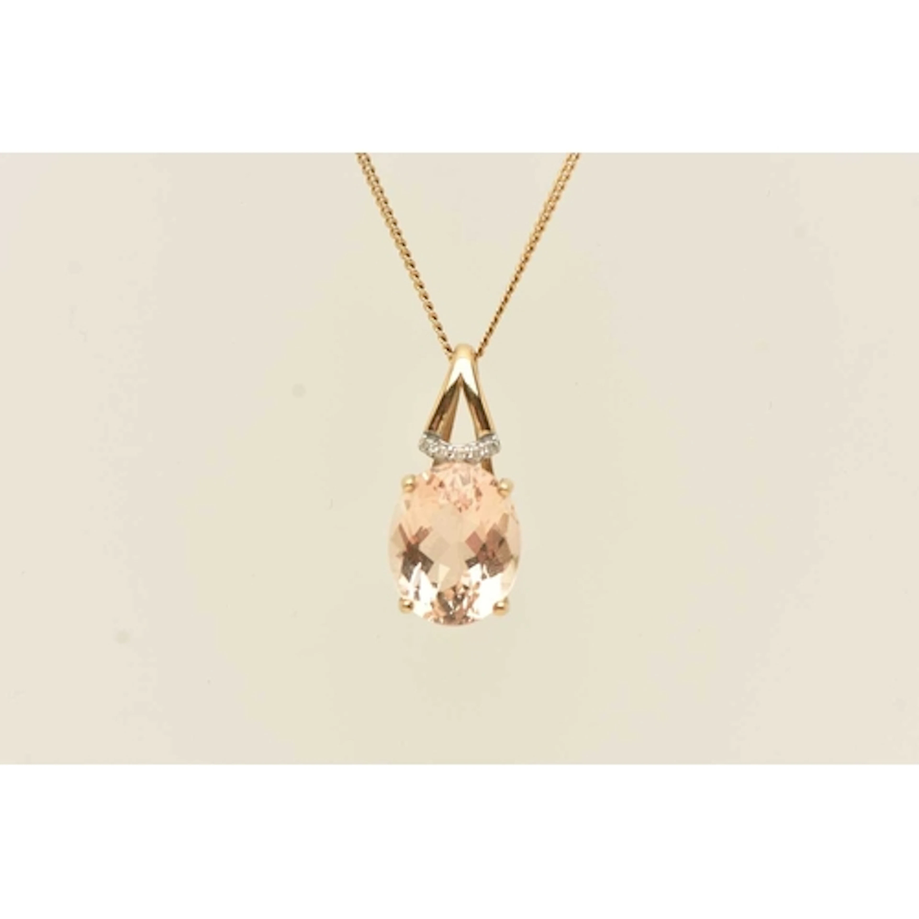 A 9CT YELLOW GOLD GEM SET PENDANT NECKLACE, an oval cut ligh...