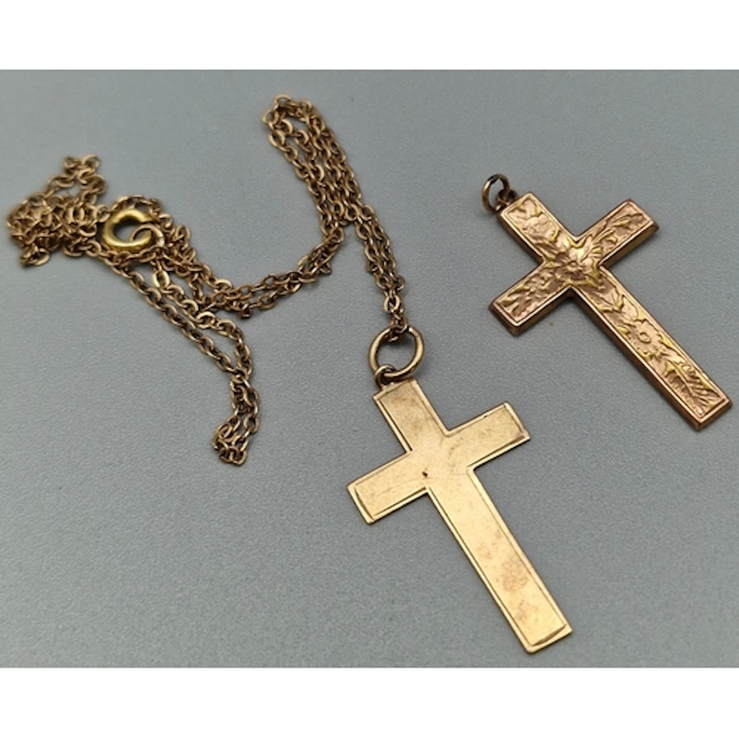 Two 9ct gold crucifix pendants, together with a yellow metal...