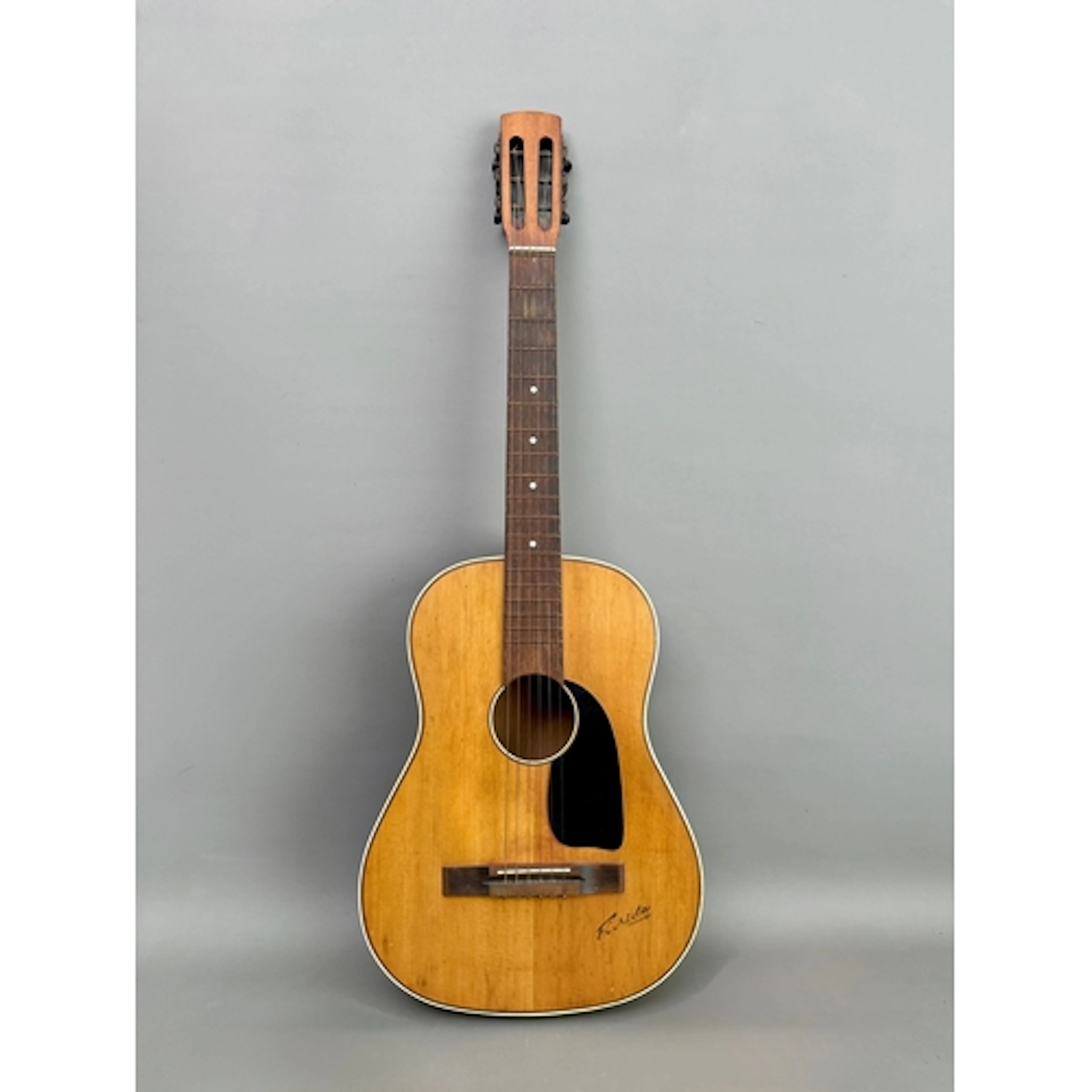 A vintage six-string acoustic guitar, marked 'Florida'.