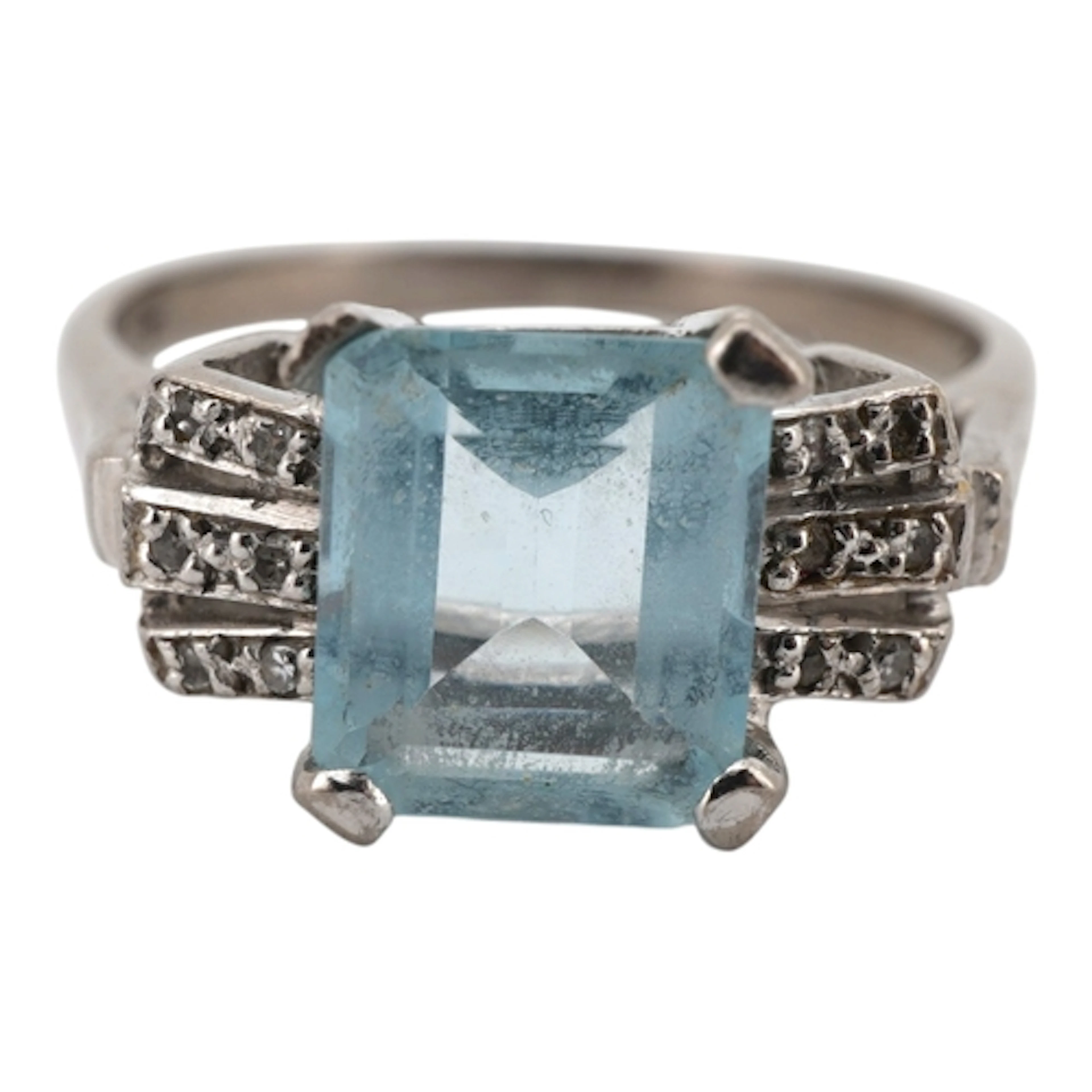 An aquamarine and diamond ring, claw-set with a step-cut aqu...