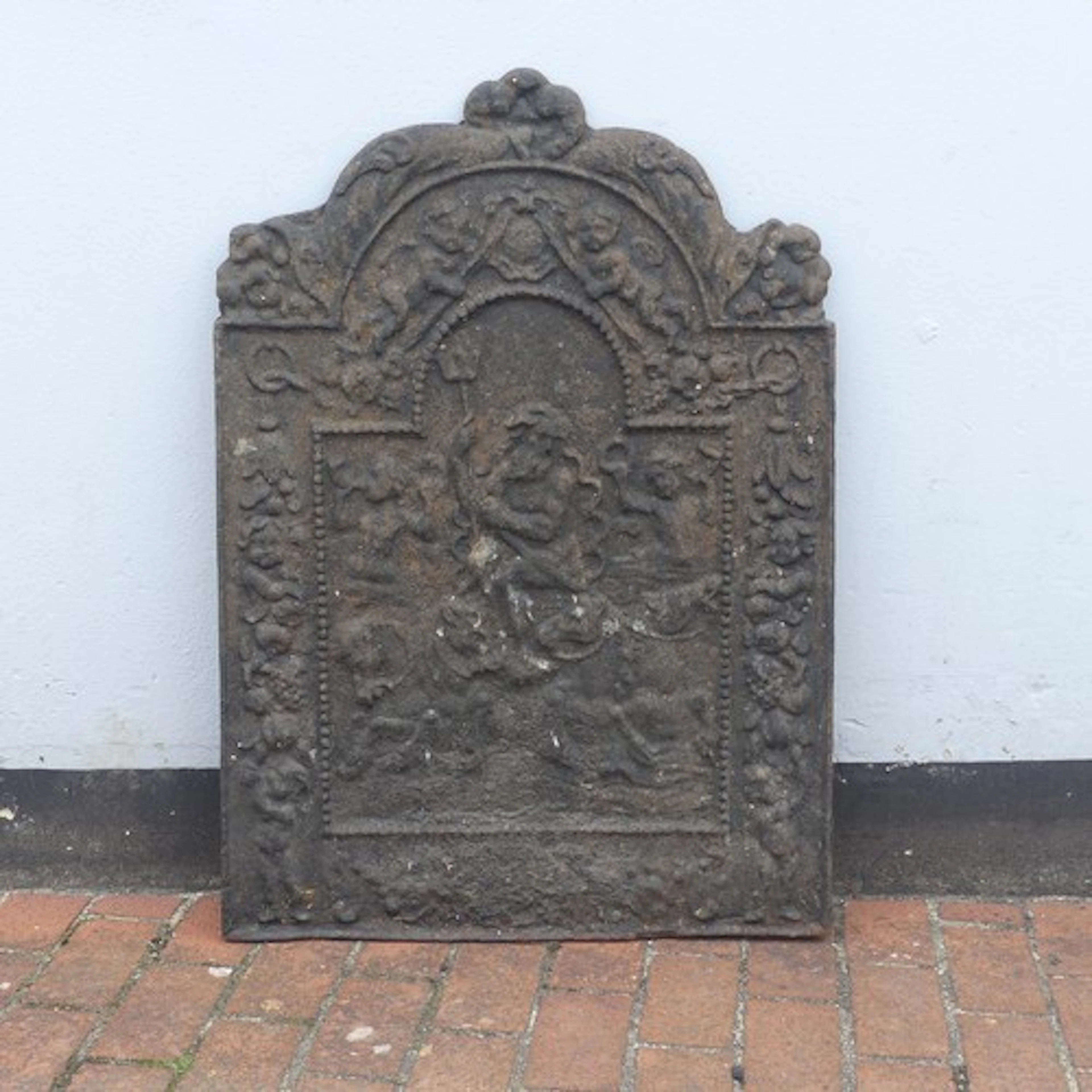 A Carolean style cast iron Fireback, W:69cm x H:98cm....