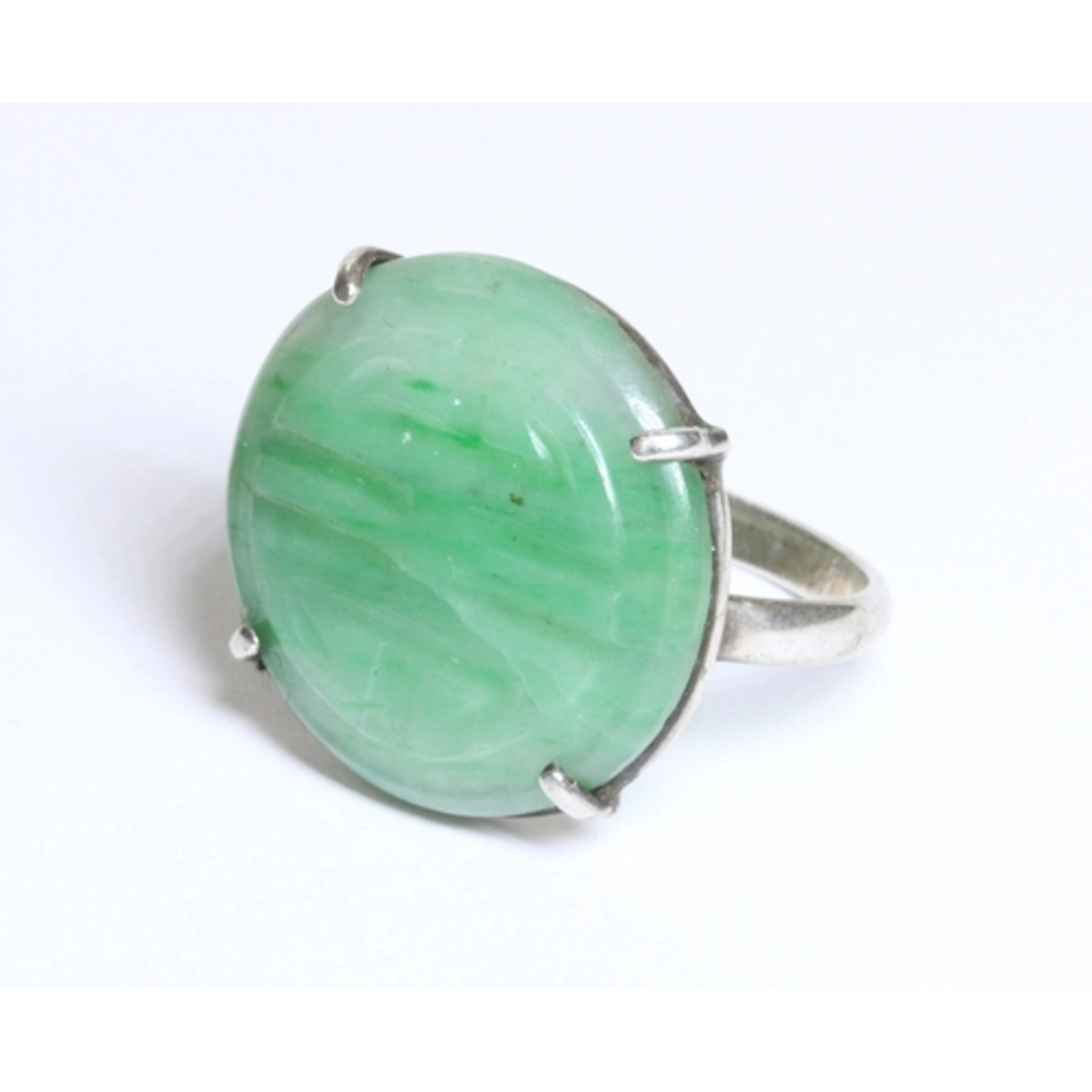 An early 20th century jadeite jade cabochon ring, the round ...