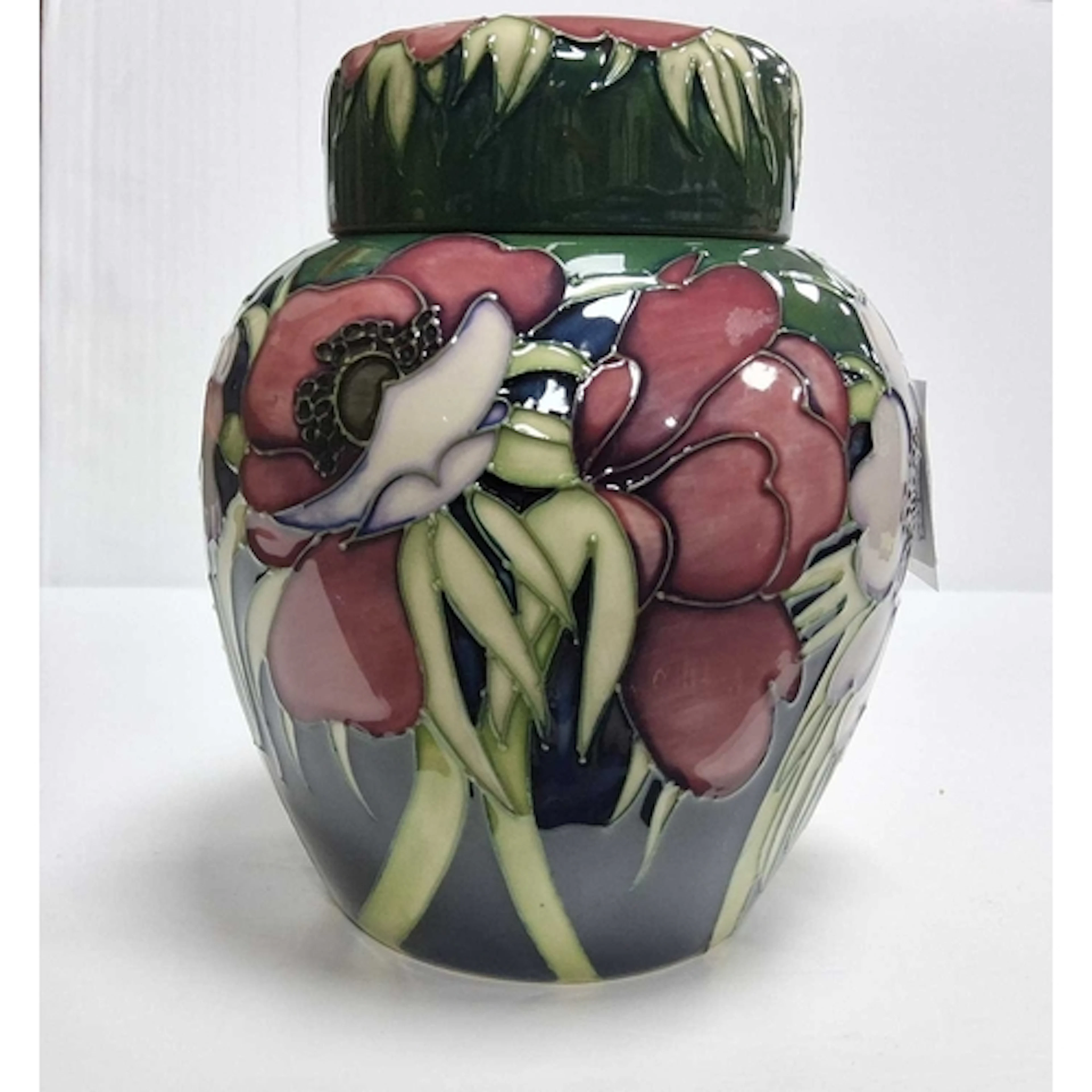 A MOORCROFT POTTERY COVERED GINGER JAR, featured in the tube...