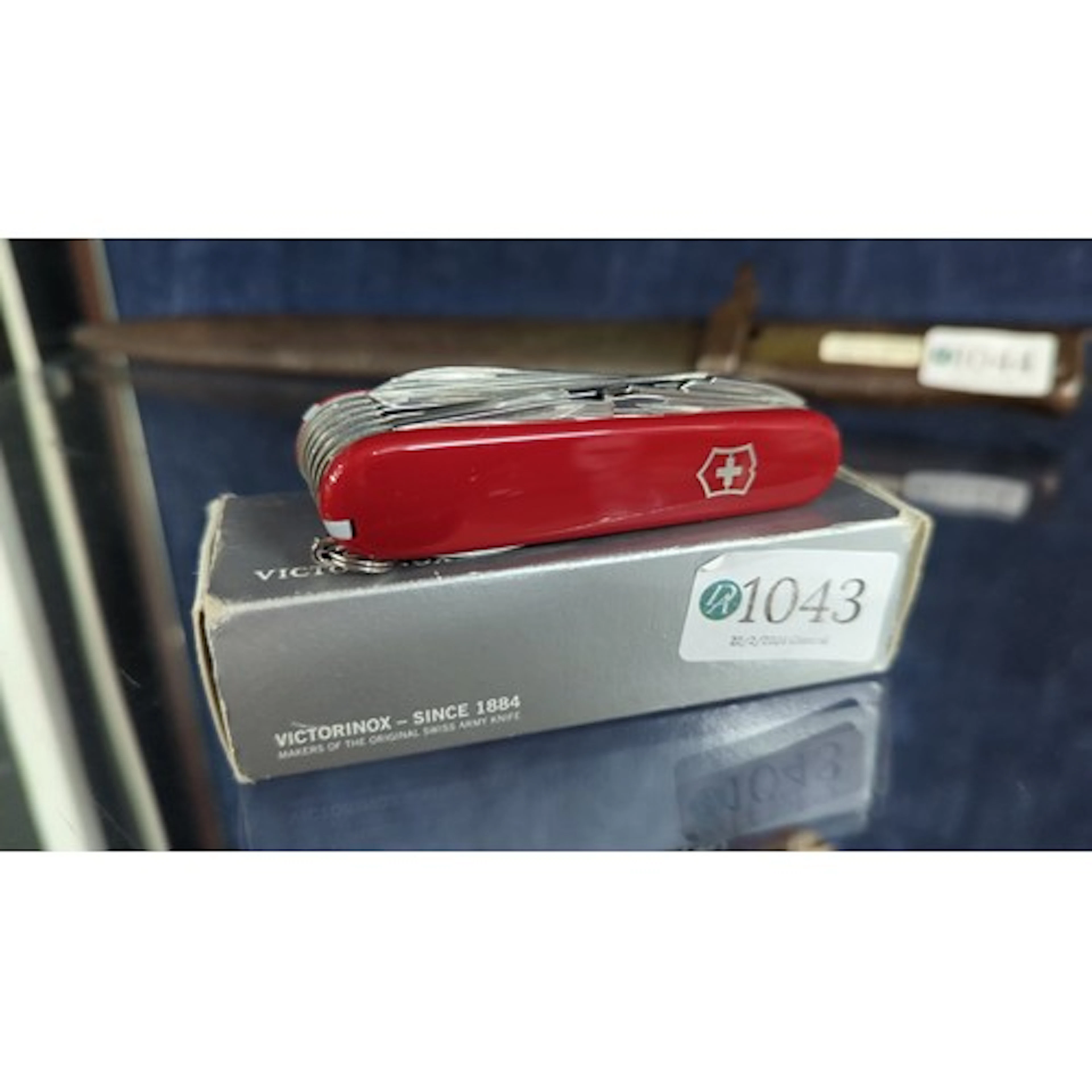 A Victorinox Swiss Army multi-tool pocketknife with red cell...