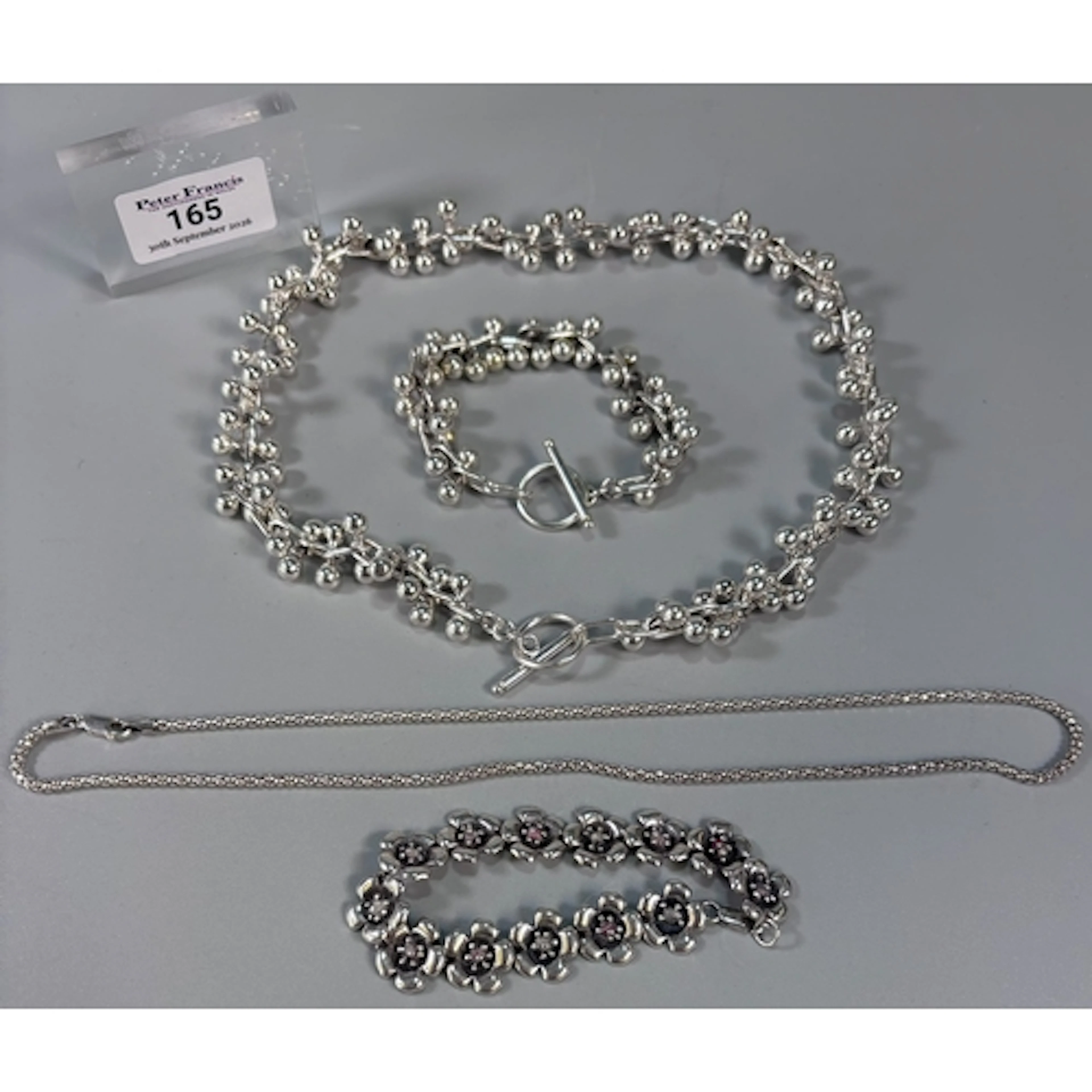 Modernist design silver flower head bracelet, together with ...