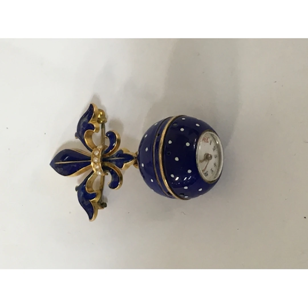 A lady's yellow metal and blue enamel ball fob watch, having...