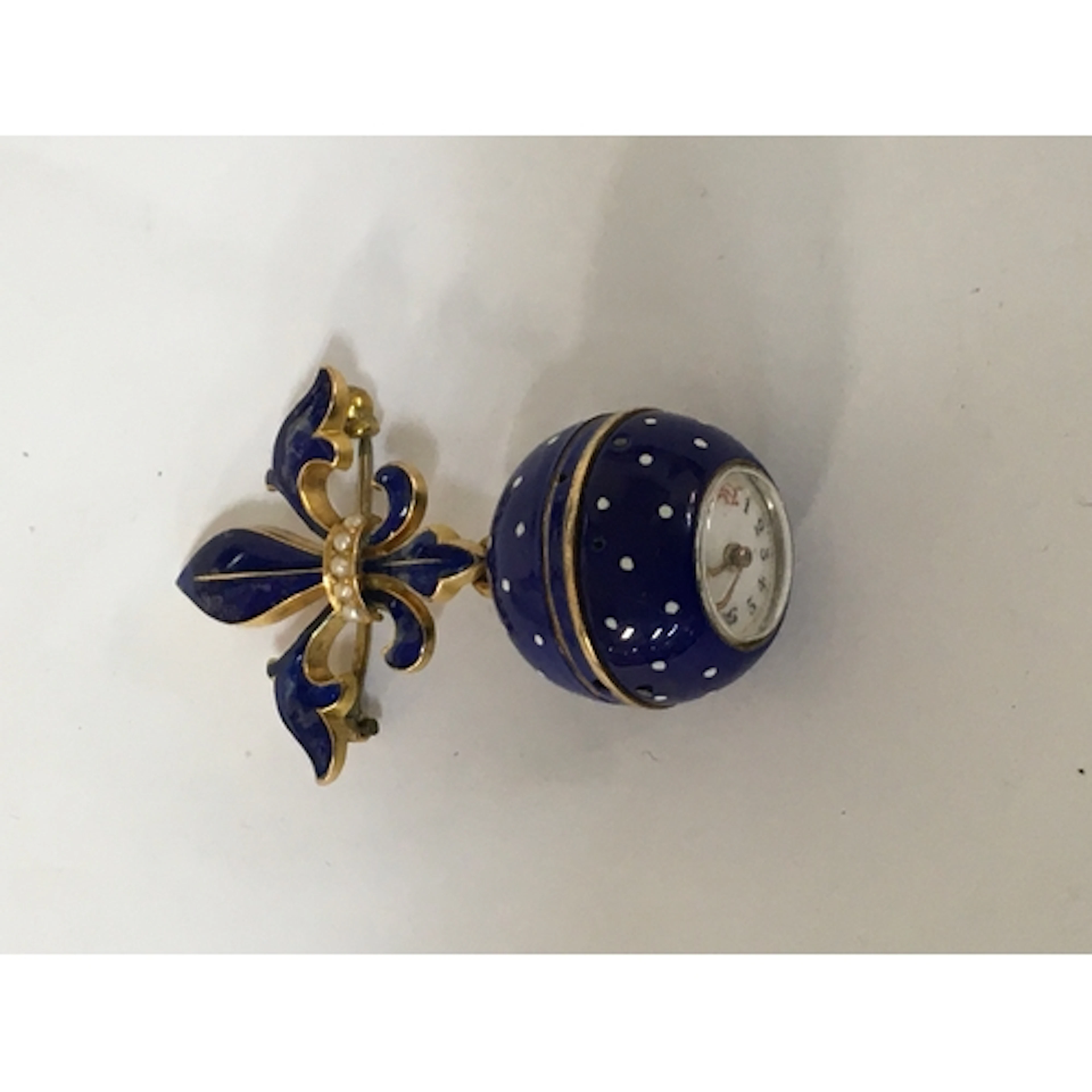 A lady's yellow metal and blue enamel ball fob watch, having...