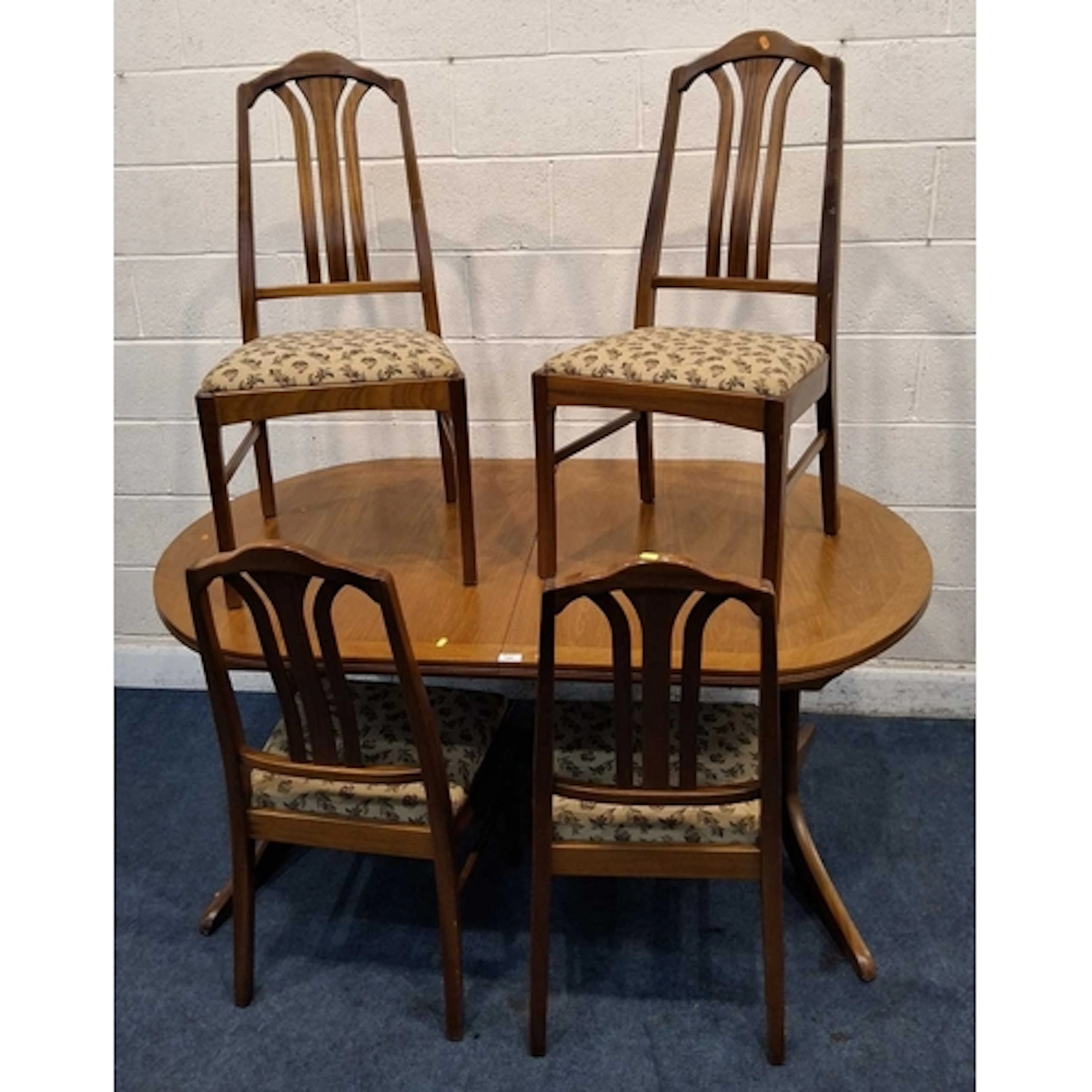 PARKER KNOLL, A MID-CENTURY TEAK OVAL EXTENDING DINING TABLE...