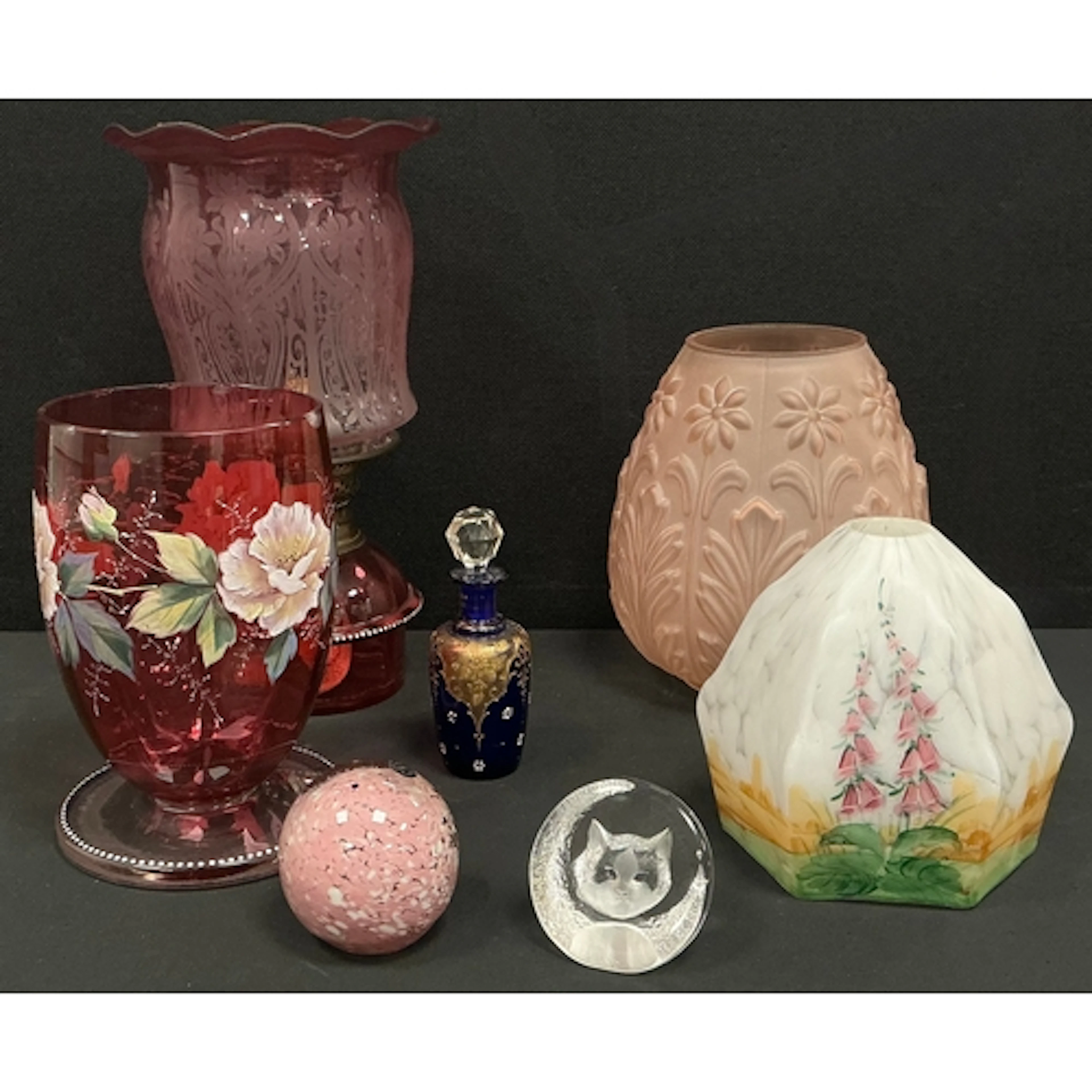 A 20th century oil lamp featuring a cranberry glass reservo...