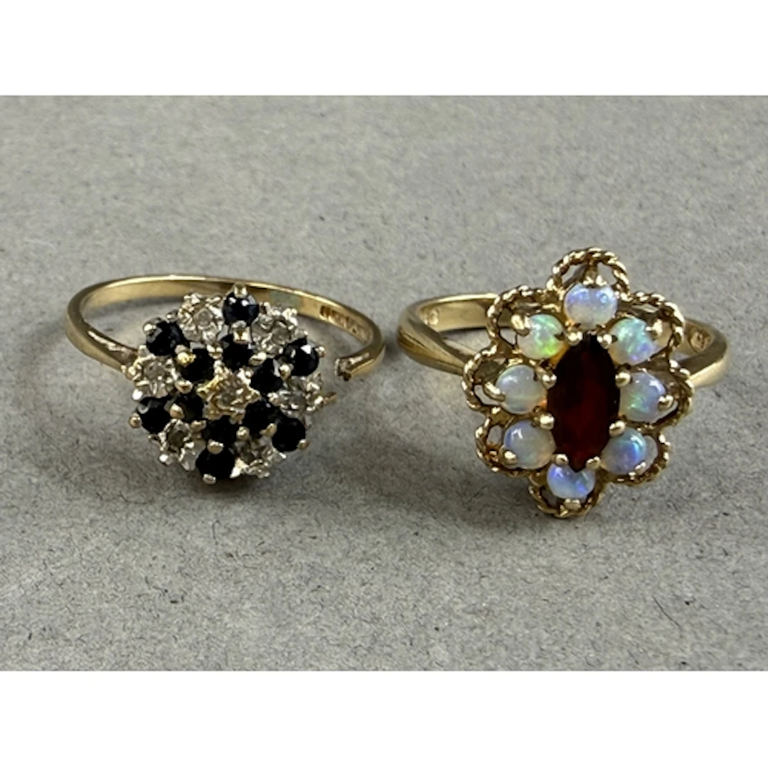 Jewellery: a 9ct yellow gold ring set a central marquise cut...