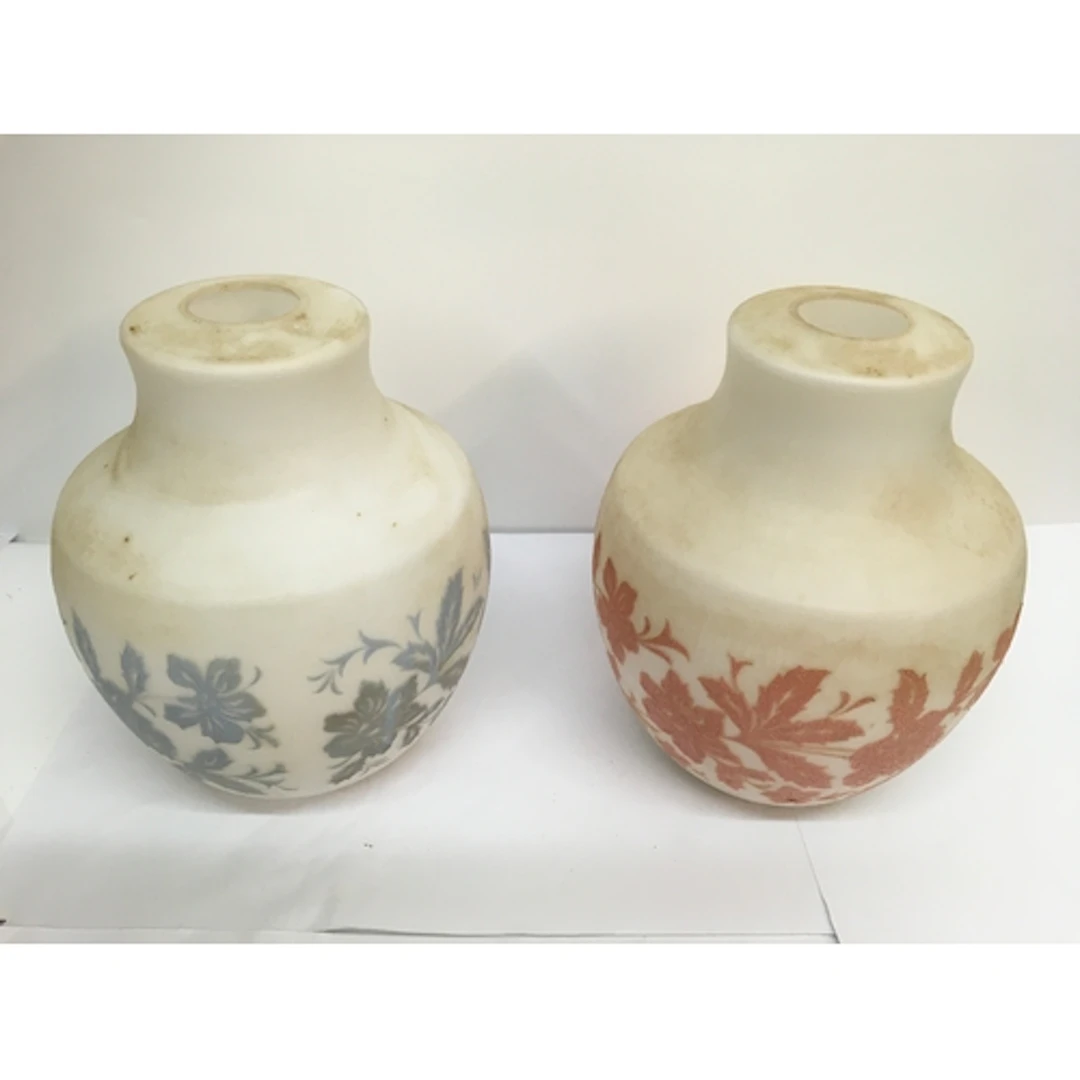 A pair of opaque glass shades relief decorated with coloured...