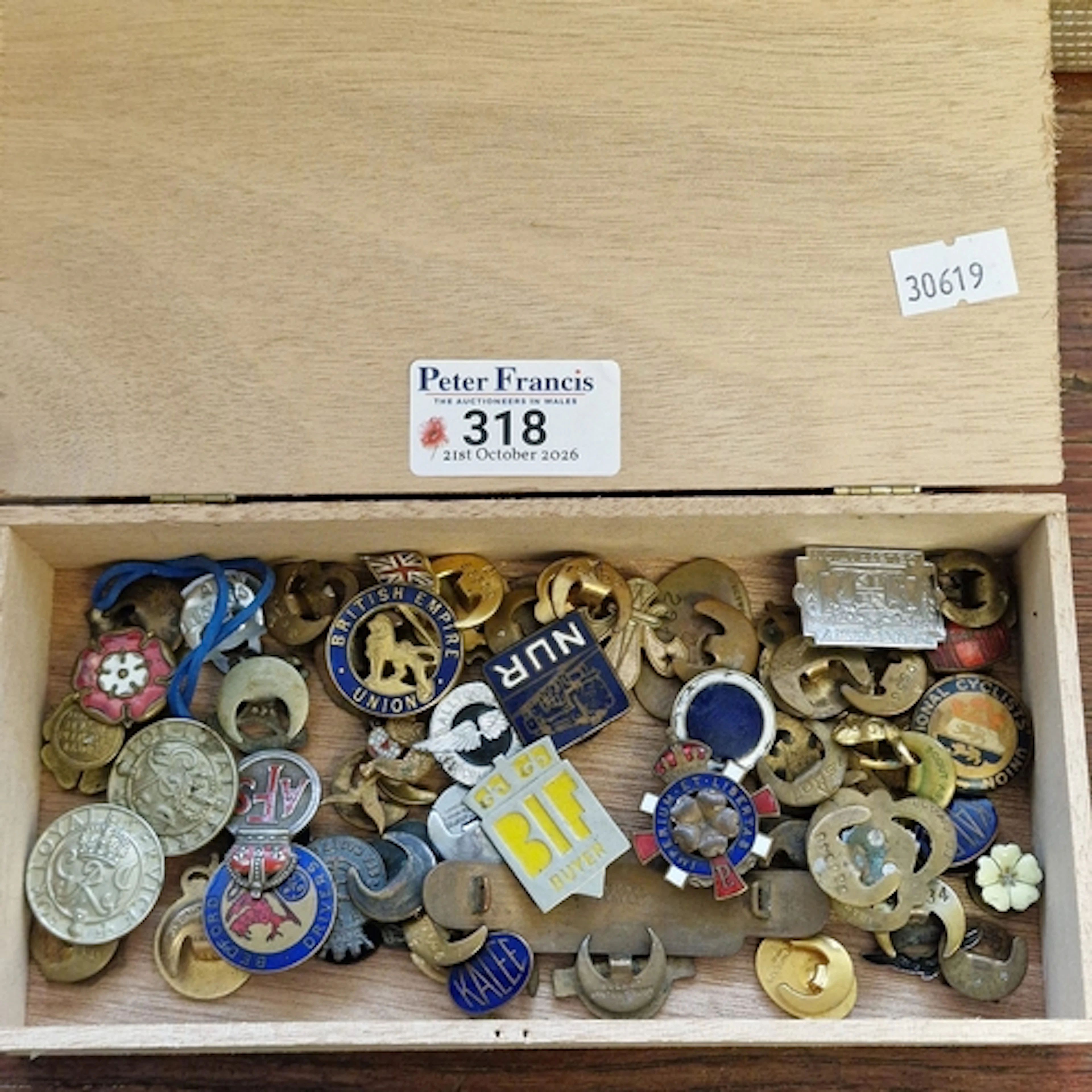Cigar box comprising assorted pin badges of varying designs ...