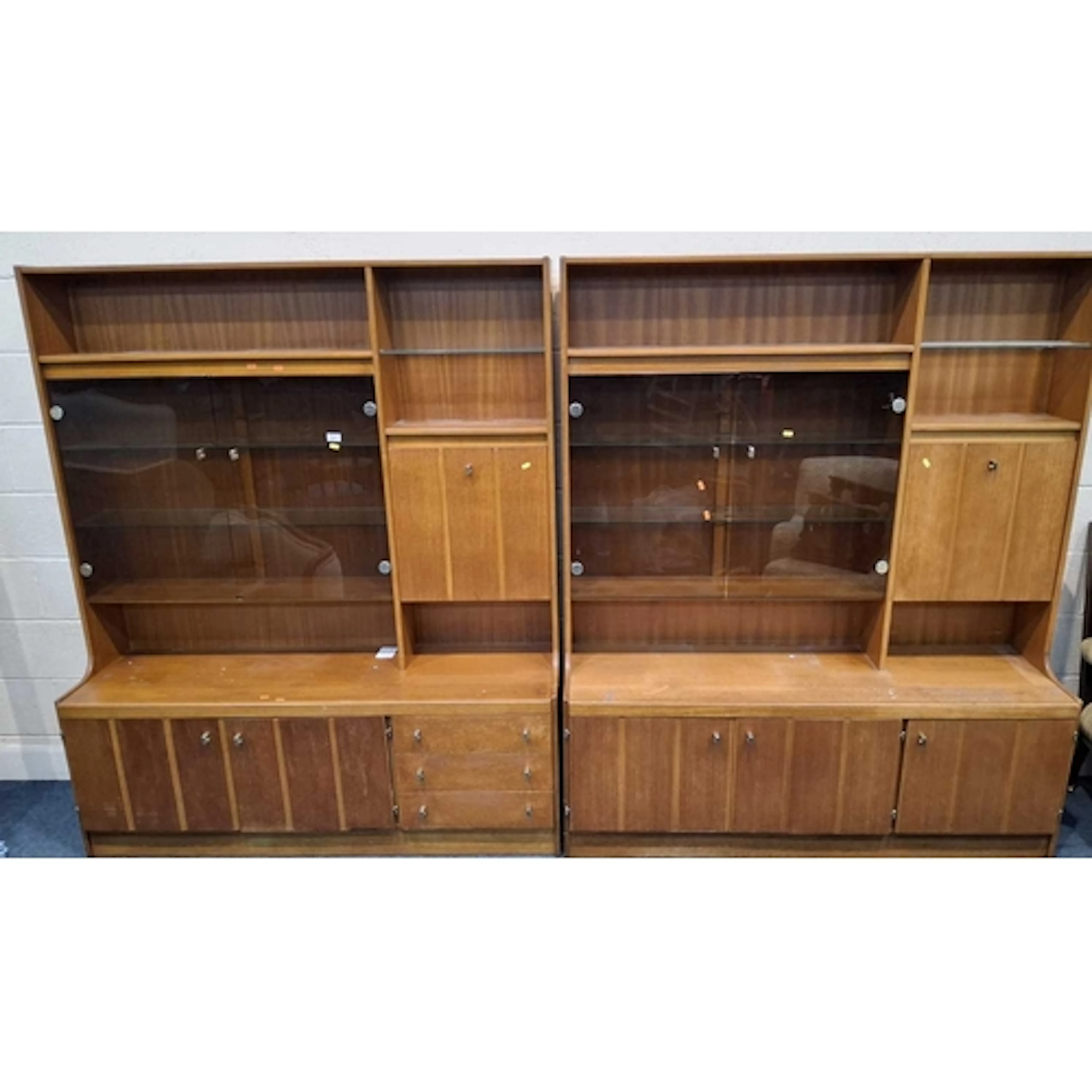 TWO MID-CENTURY TEAK WALL UNITS, each fitted with double smo...