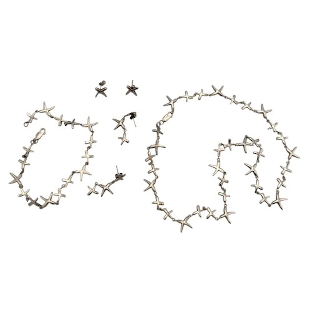 A silver and unmarked silver metal necklace, bracelet and ea...