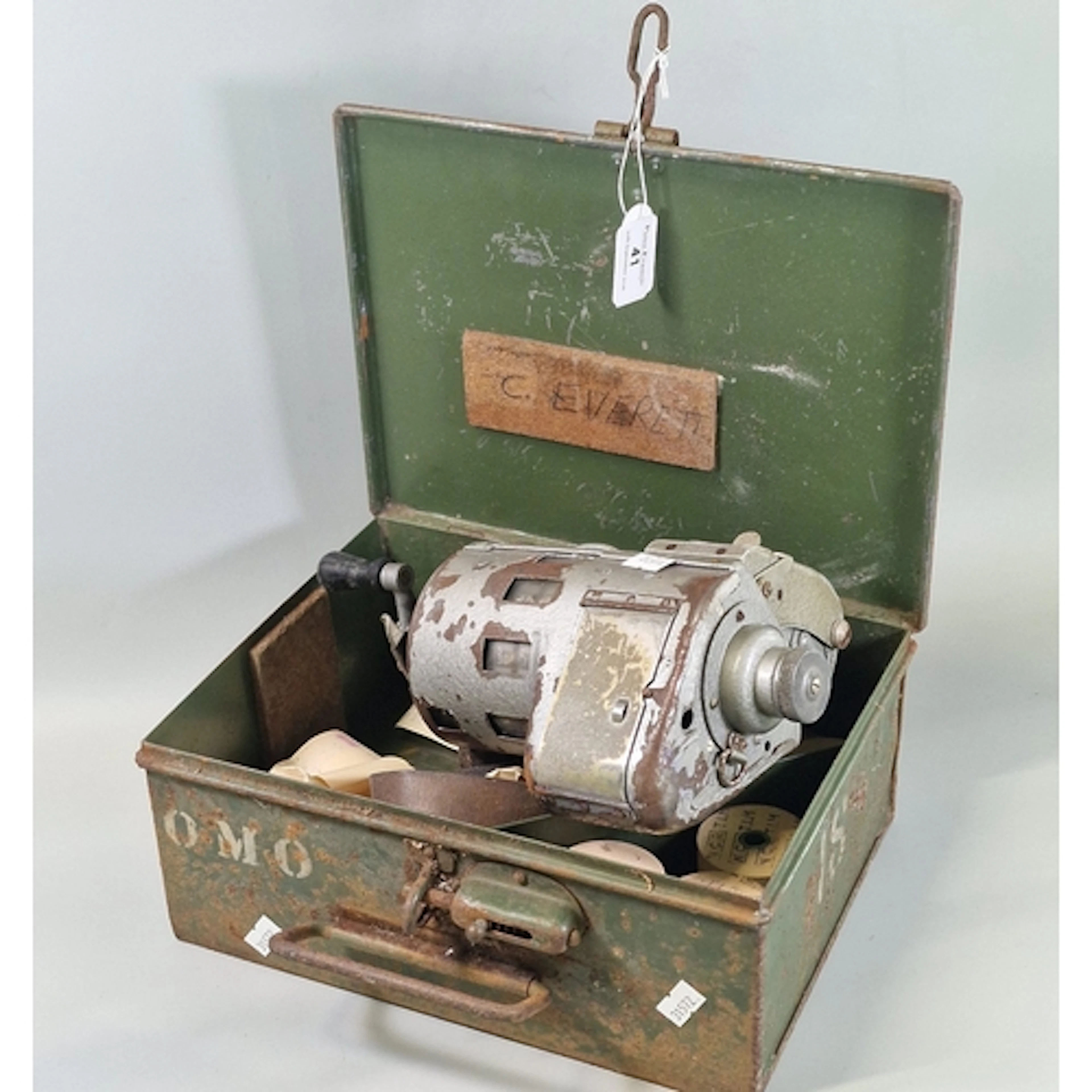 Vintage tin box containing a mechanical bus conductor’s tick...