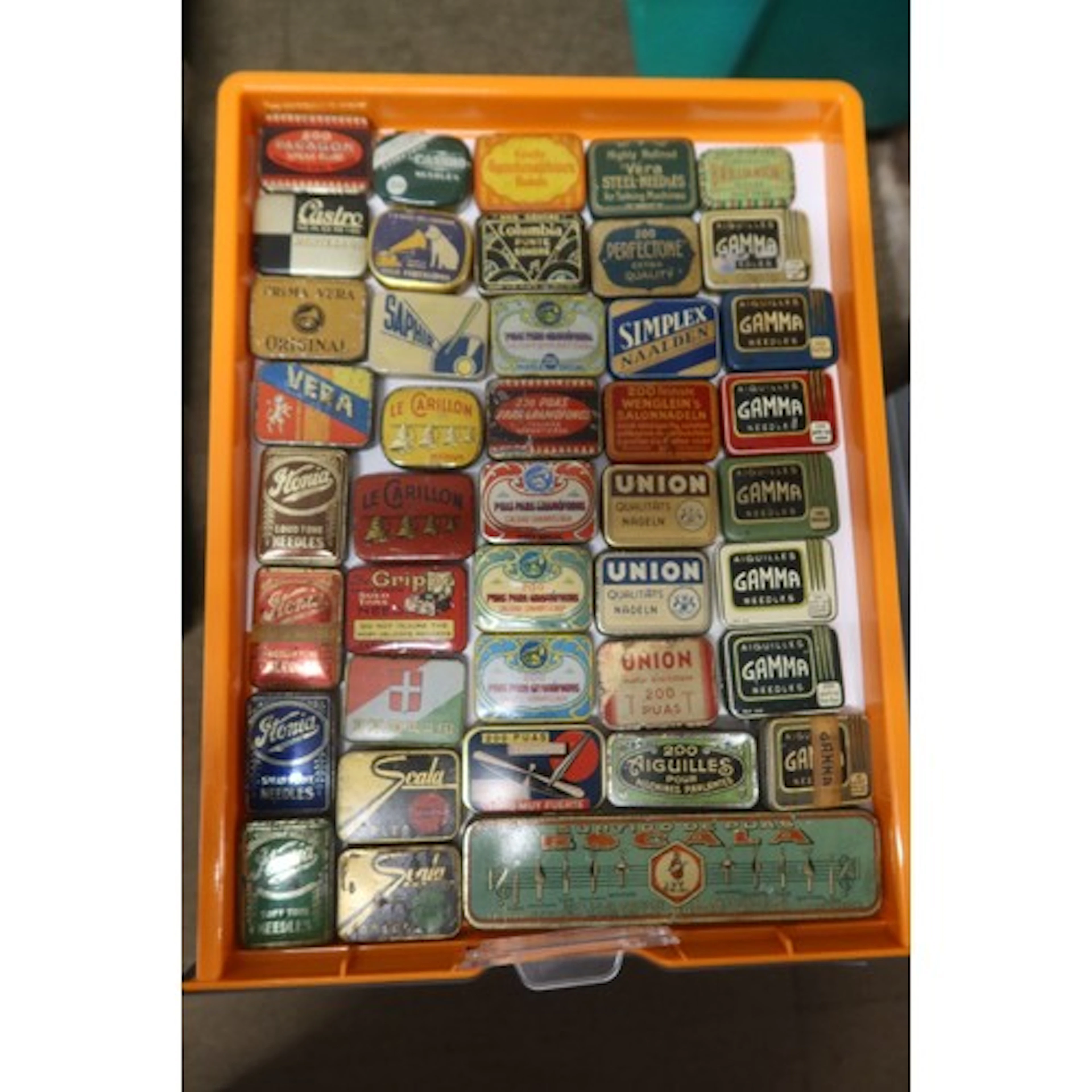 A tray of vintage gramophone needle tins