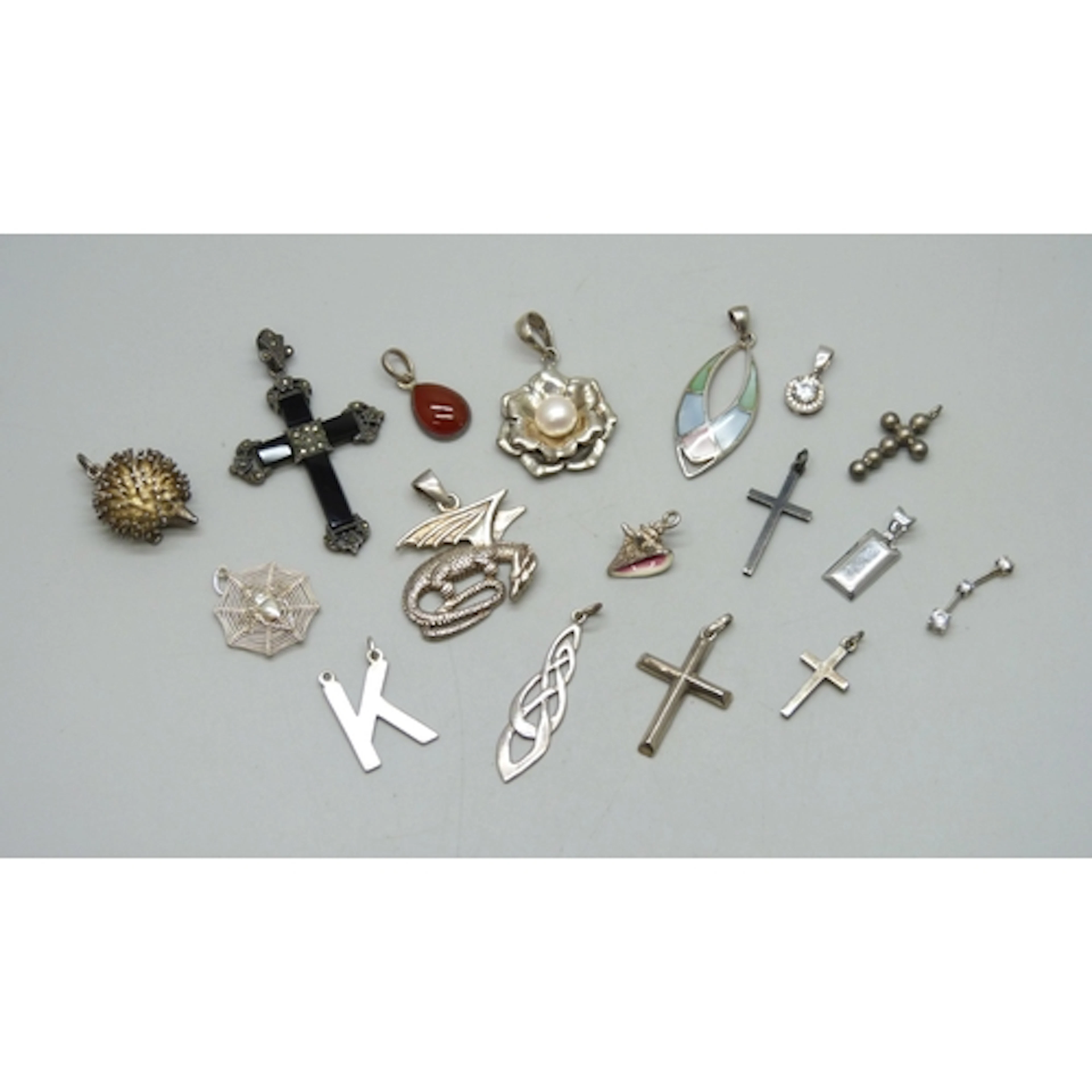 A collection of silver and white metal pendants, 48g