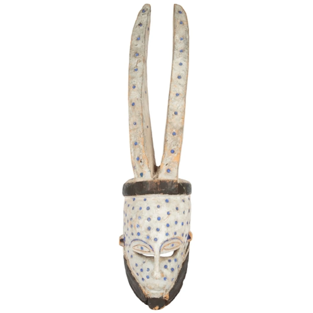 An Edo-Bini Azigho white and blue painted horned tribal mask...