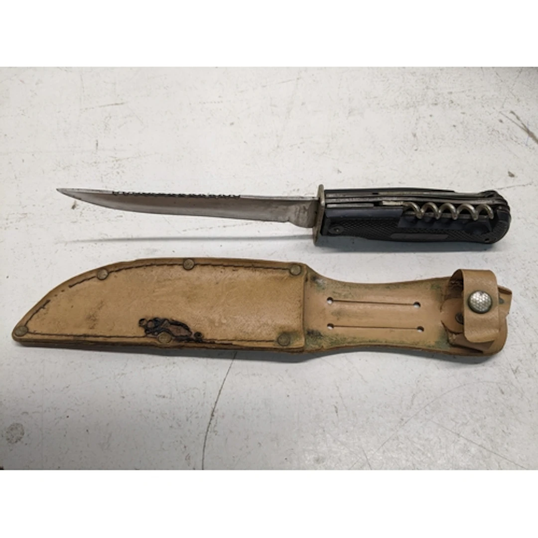 A German Solingen hunting knife and multi tool, in a brown l...
