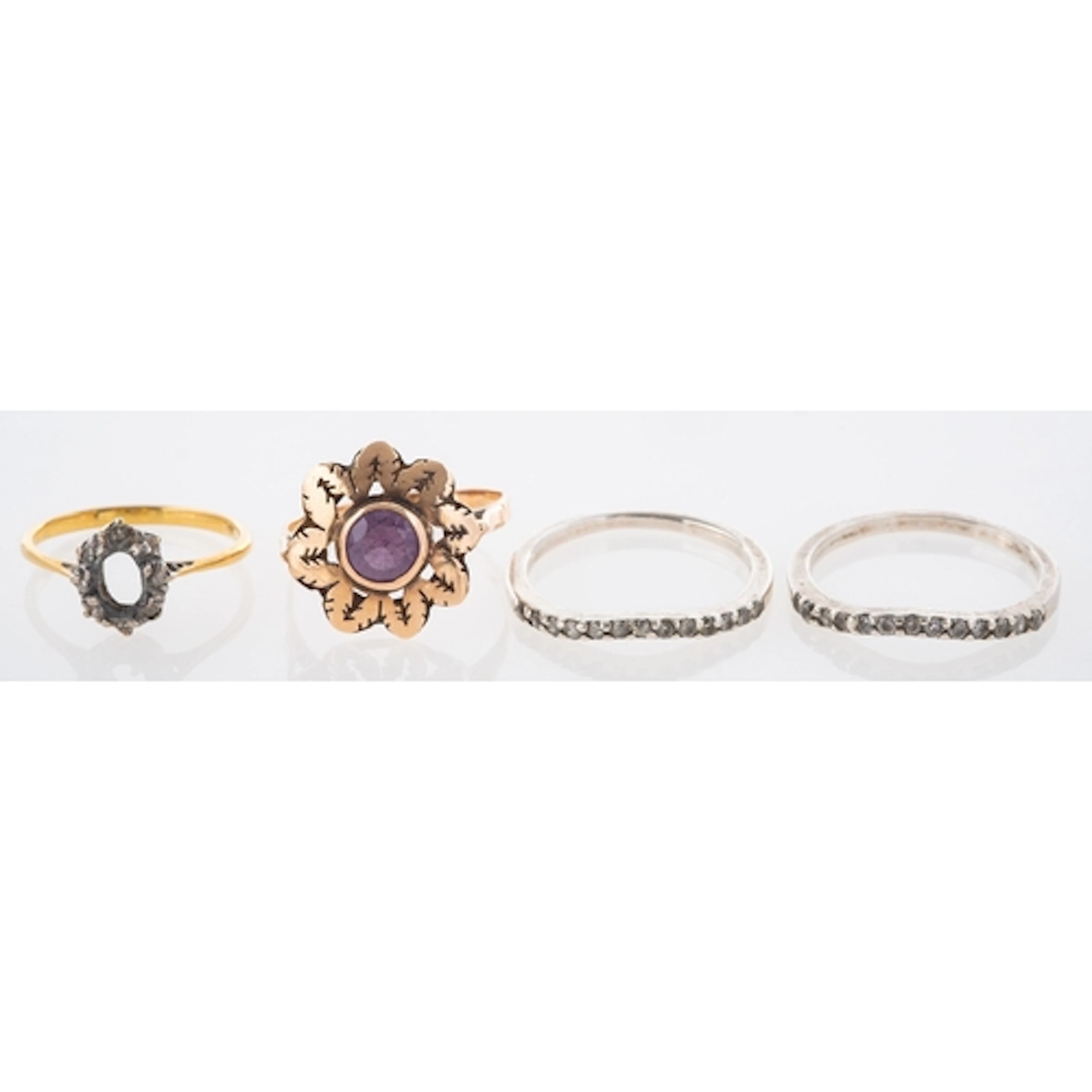 A Collection of Four Rings, including a 14K marked synthetic...